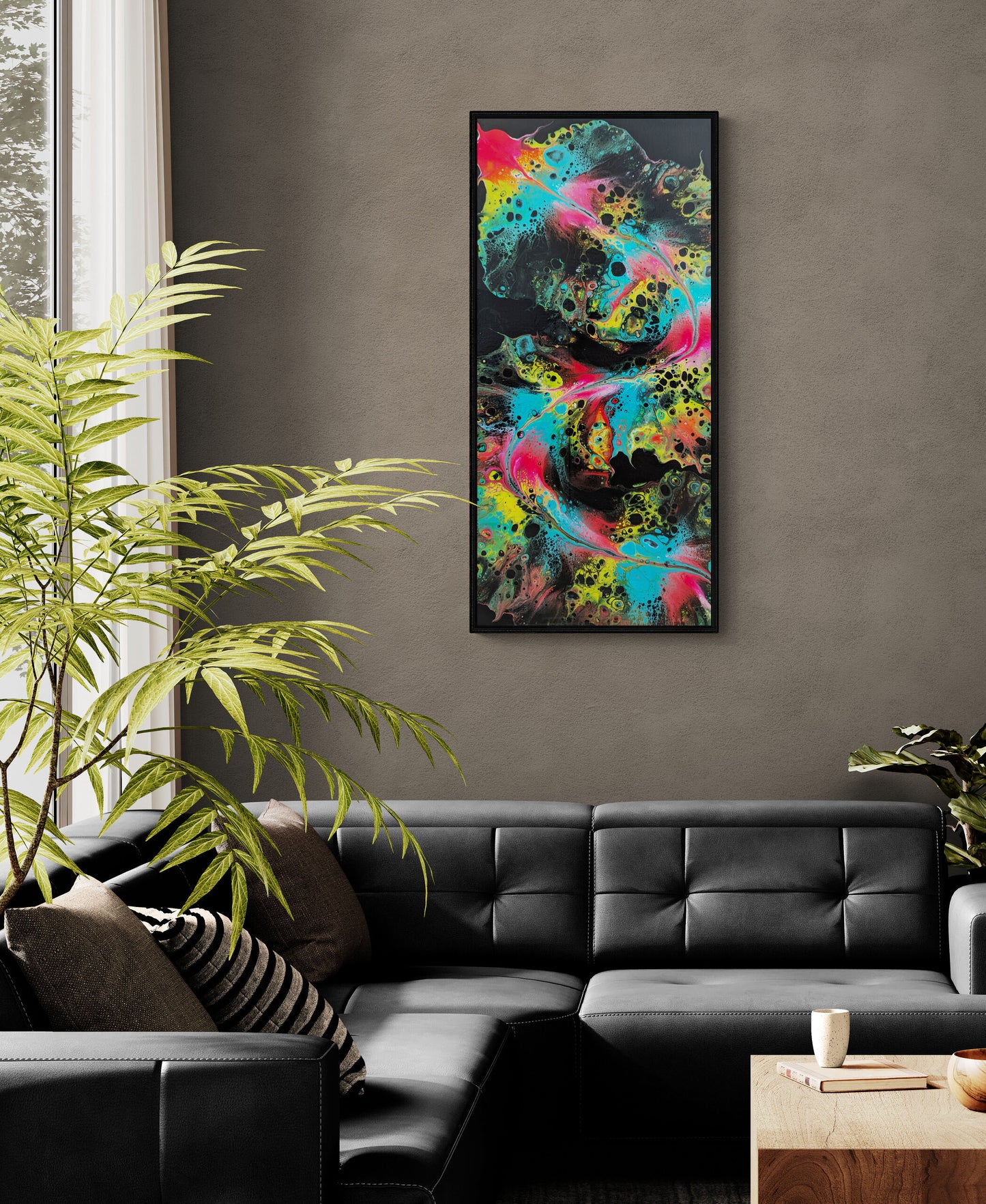 Framed abstract painting titled "Koi (Yin)" hanging above a black leather sectional in a modern living room with gray walls, a tall green plant, and a wooden coffee table.