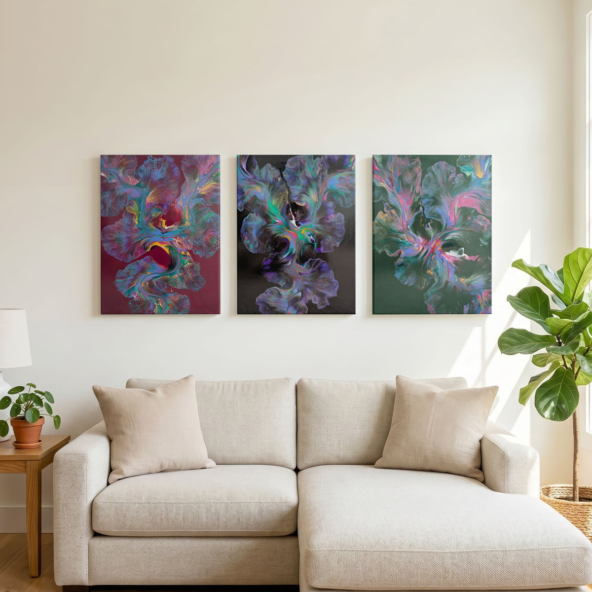 Original fluid art paintings from left to right: Ember Glow, Celestial Dance, and Enchanted Sky. These pieces are hanging above a cream couch with plants on either side