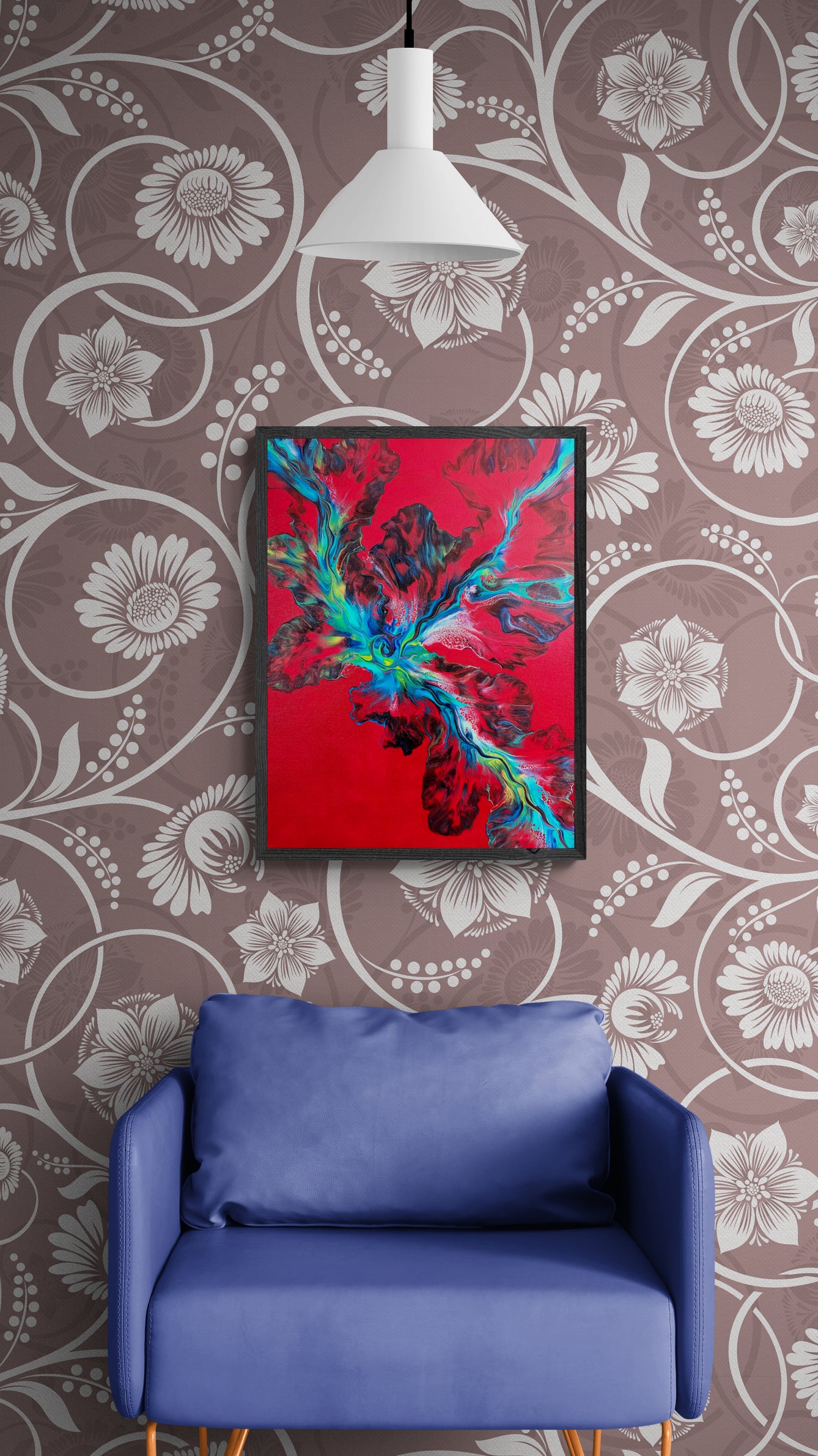 The painting "Elemental Surge" hangs on a wall with oversized floral wallpaper, above a rich periwinkle armchair. A white pendant light hangs above the vivid red and teal abstract artwork, which radiates movement and energy.