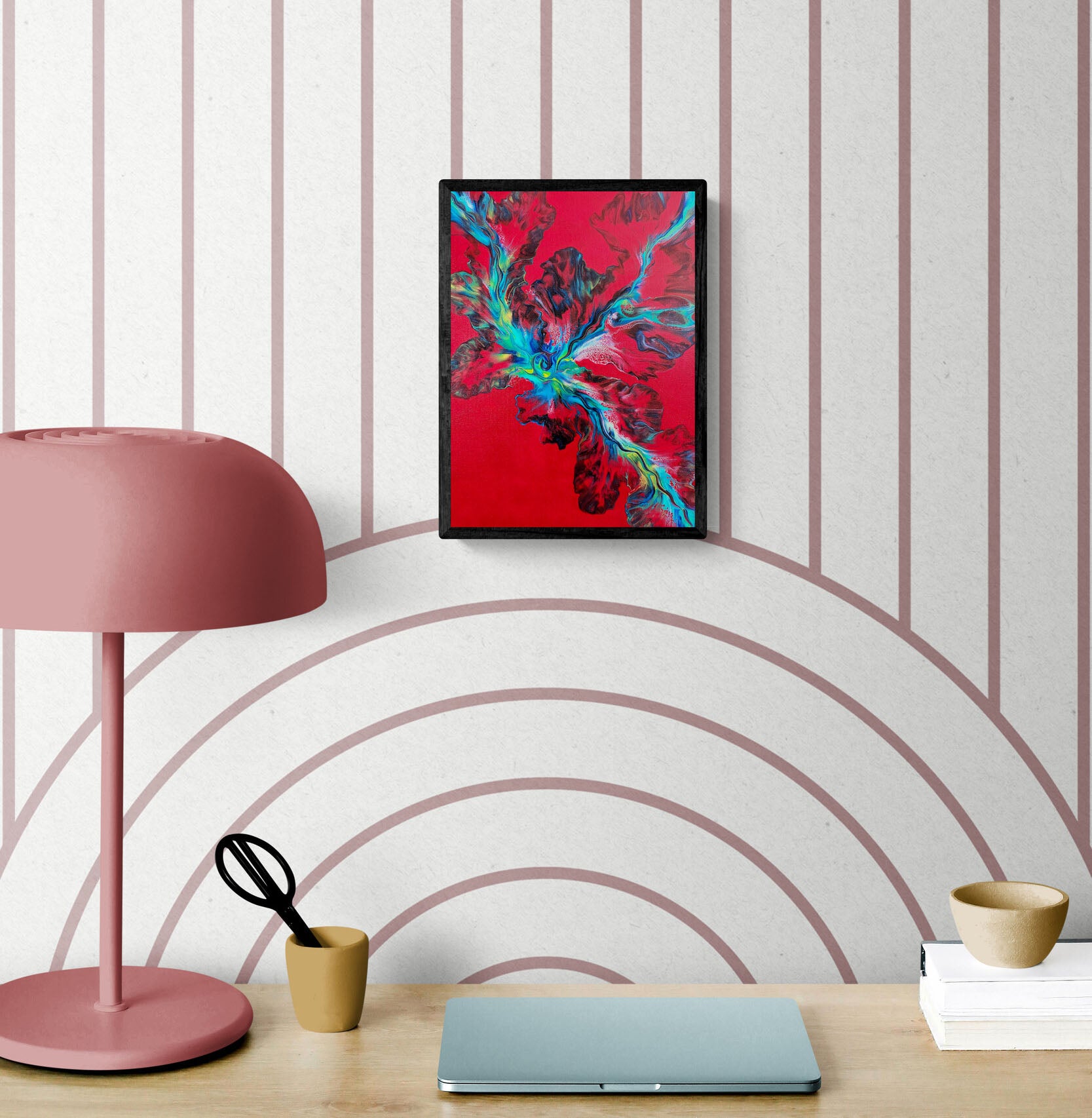 Elemental Surge – abstract fluid art print in bold red, blue, and green tones, framed wall art styled above a modern desk with pink lamp and laptop