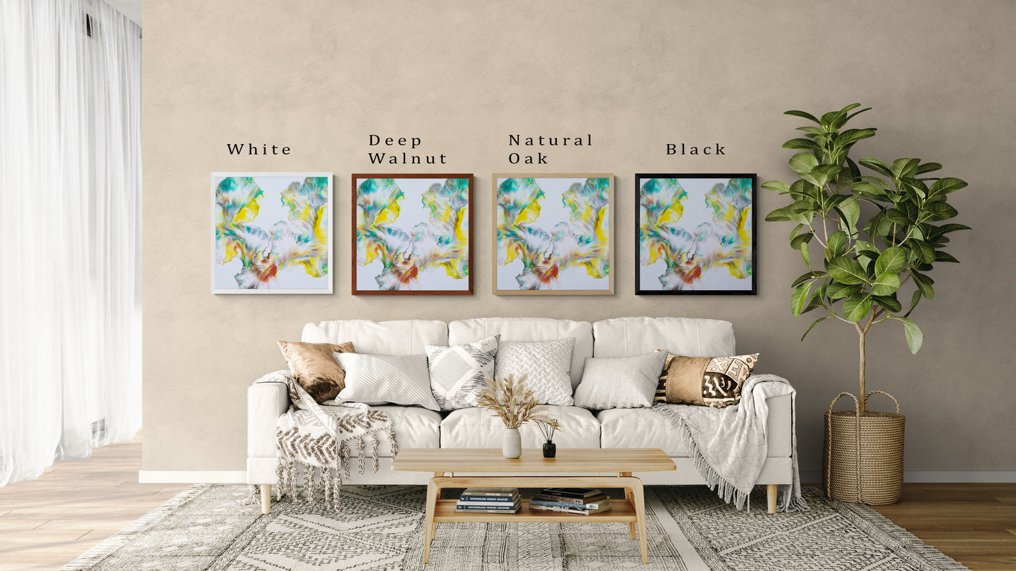 Four framed prints of Abby May Art’s painting “First Daffodils of Spring” displayed above a cozy cream sofa in a neutral living room. The artwork features soft fluid swirls of yellow, teal, green, and hints of copper on a light background, evoking early spring blooms. Each print is shown in a different frame color—White, Deep Walnut, Natural Oak, and Black—with labels above each frame. The scene includes textured throw pillows, a light wood coffee table, and a potted plant.