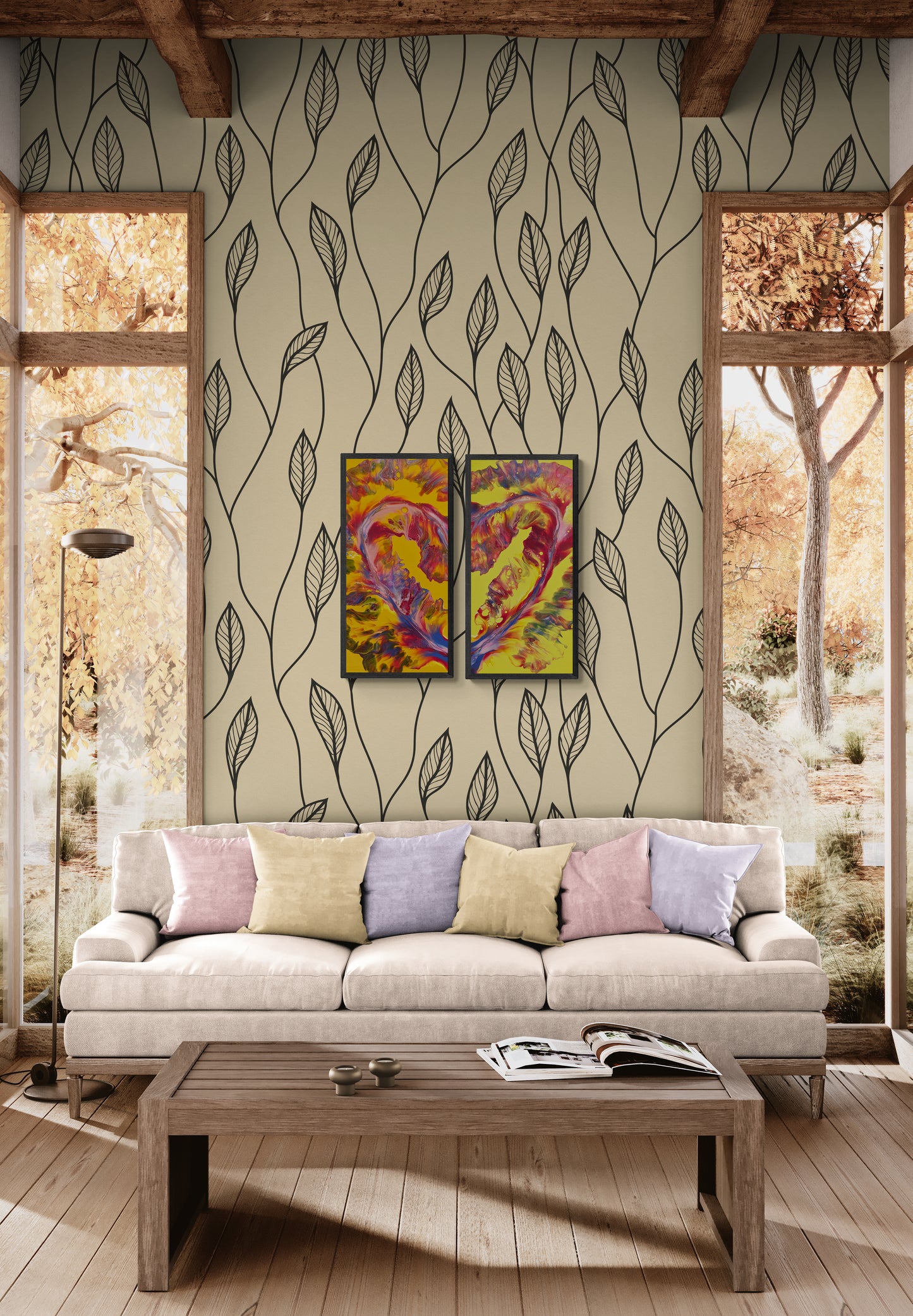 Two-part heart-shaped abstract painting with vivid yellow, pink, red, and lavendar tones displayed above a neutral-toned couch in a cozy living room with nature-inspired wallpaper and soft fall scenery through large windows.