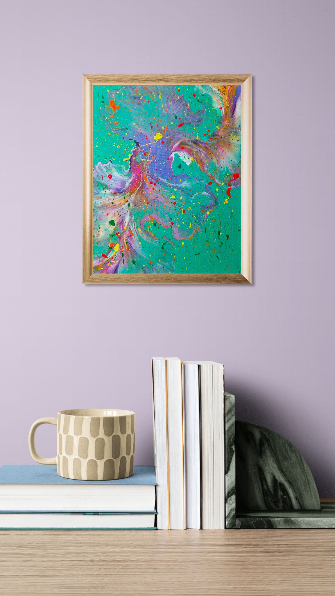 'Have You Lost Weight?' painting in a gold frame on a lilac wall above stacked books and a beige patterned mug, styled with a cozy modern vibe.