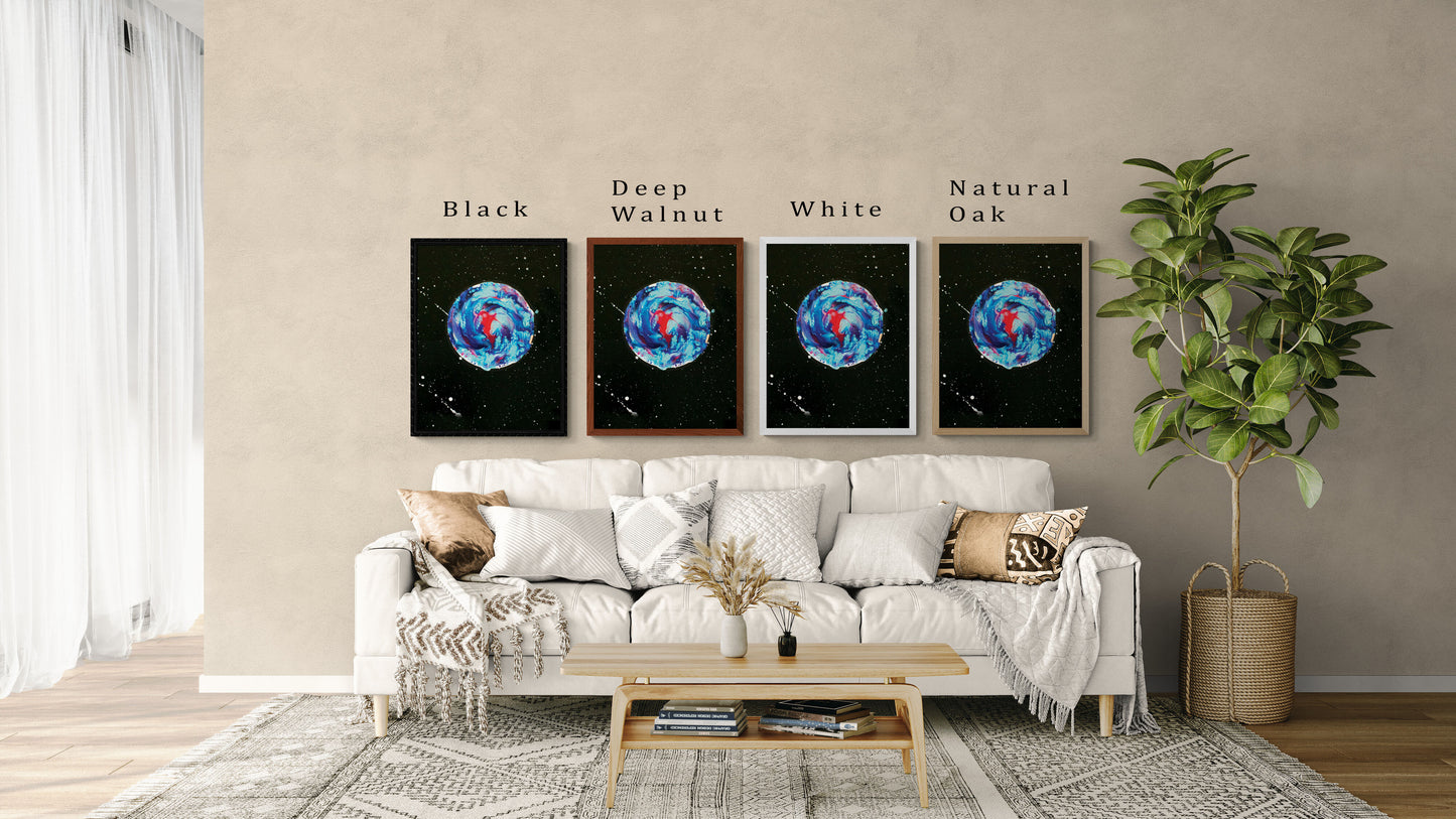 Four framed prints of Abby May Art’s “Her Majesty the Moon” displayed above a neutral cream sofa in a modern living room. The artwork features a swirling blue, teal, and magenta moon against a black starry sky with white splatter details. Each frame shows a different color option—Black, Deep Walnut, White, and Natural Oak—with labels above each. The space includes layered throw pillows, a light wood coffee table, and a tall green plant, helping viewers imagine how the artwork looks in a home setting.