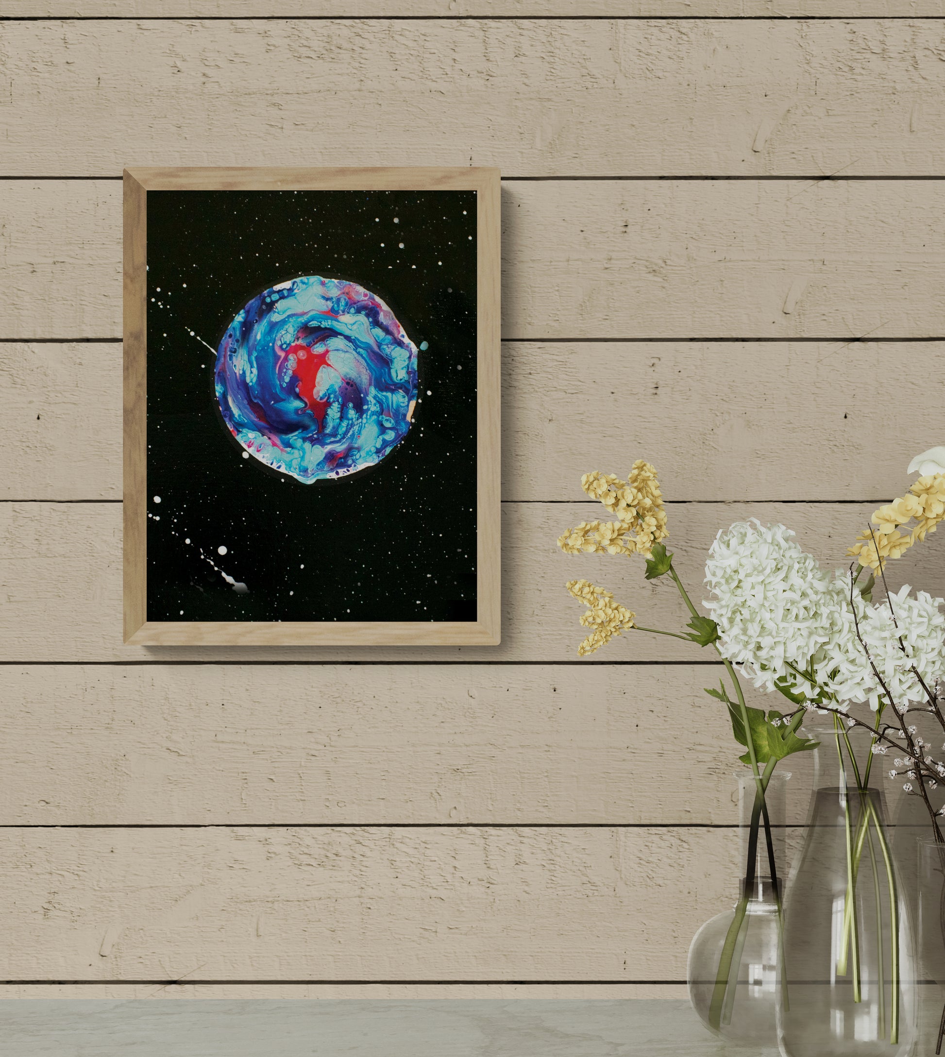 Her Majesty The Moon art print in light wood frame, styled in a minimal decor space with neutral wood paneling and simple floral vases