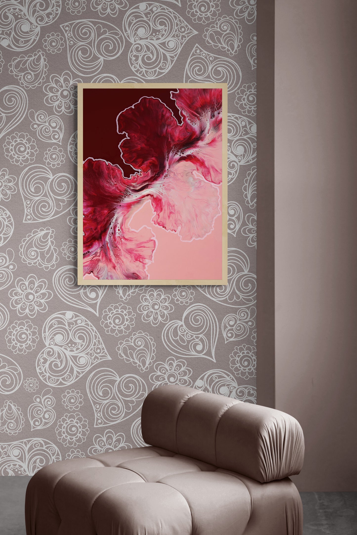 The canvas print “Hold the Line” is displayed vertically above a modern mauve lounge chair against a heart and floral patterned wall. Its bold maroon and pink tones create a striking contrast with the neutral space, infusing it with energy and elegance.
