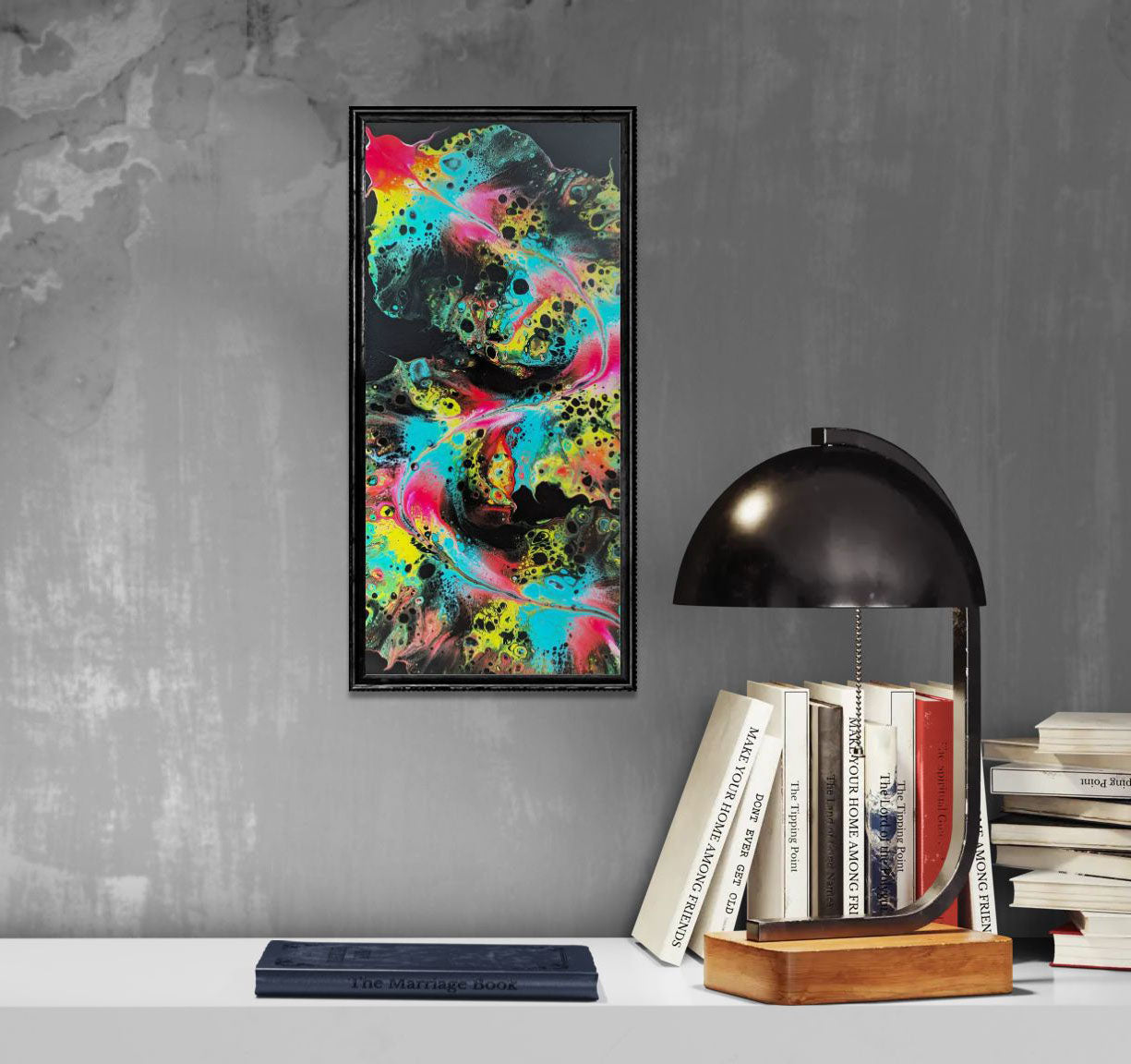 ramed abstract painting titled "Koi (Yin)" displayed on a modern white shelf against a textured gray wall, surrounded by books, a black dome lamp