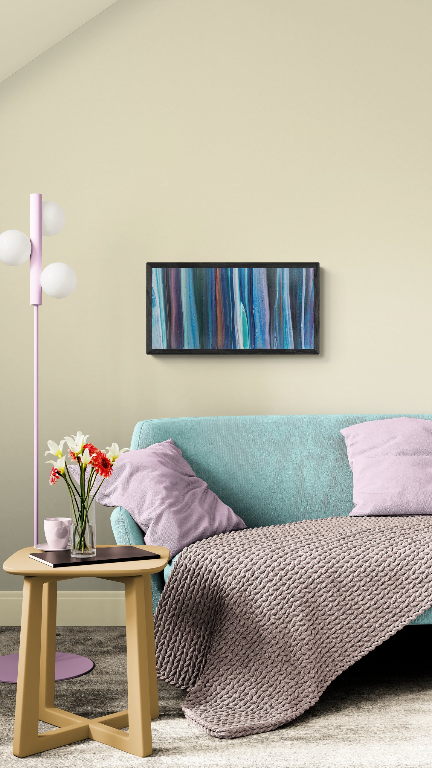 Framed abstract painting with vertical blue, purple, and copper tones displayed above a mint green sofa with lavender pillows and a knit blanket, styled with a pastel side table, flowers, and soft lighting.