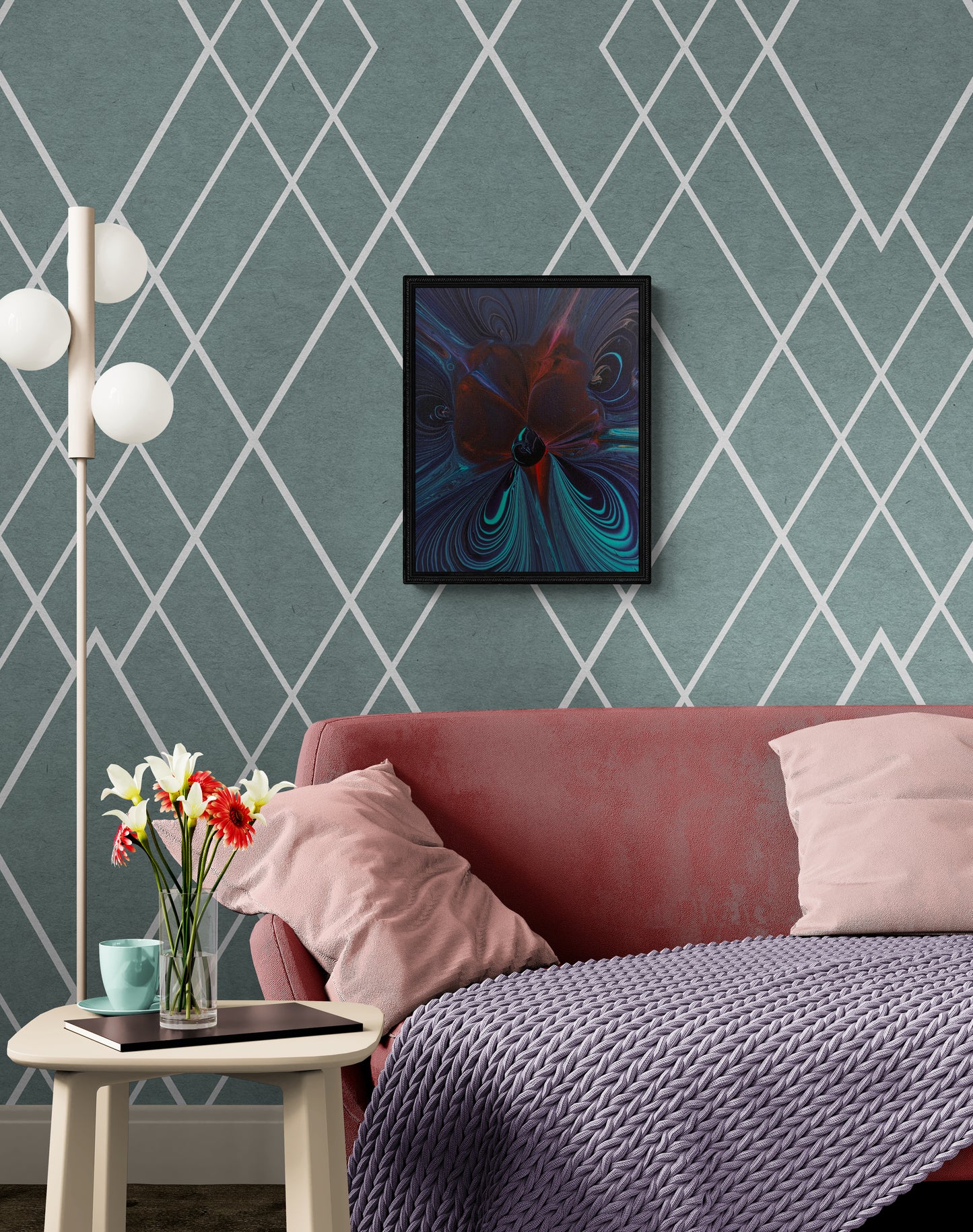 Framed dark abstract painting with swirling teal, red, and violet tones hanging on a green diamond-patterned wall above a soft red couch with blush pillows, a lavender knit blanket, and a floral-accented side table.