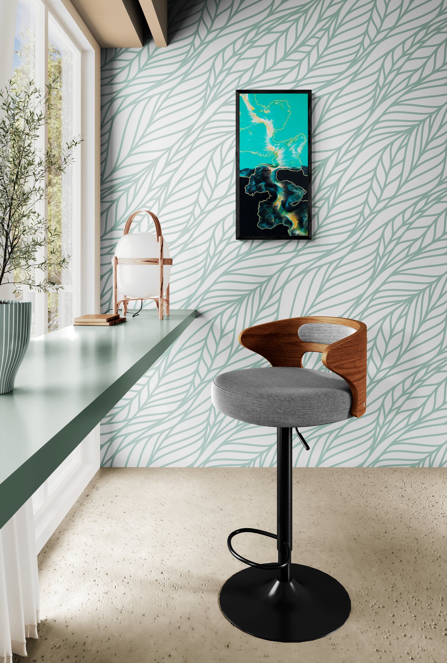 A bold abstract painting titled "Outside the Lines" is framed in black and displayed on a sage leaf-patterned wallpaper wall. The artwork features sweeping forms in teal, black, white, and gold, resembling fluid landmasses on a map. A sleek green counter with books and decor runs along a windowed wall, while a modern barstool with a wooden back and gray cushion sits nearby, creating a serene and design-forward space filled with natural light.