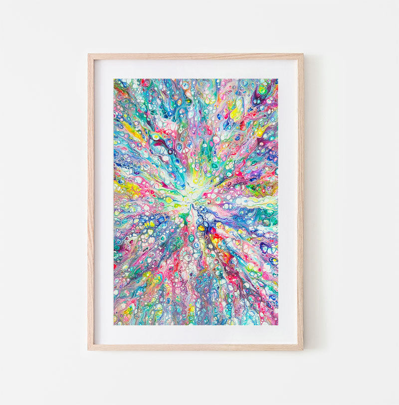 Rainbow Dragon abstract fluid art print with radiant rainbow colors and cell details, framed in light wood and styled on a white wall.