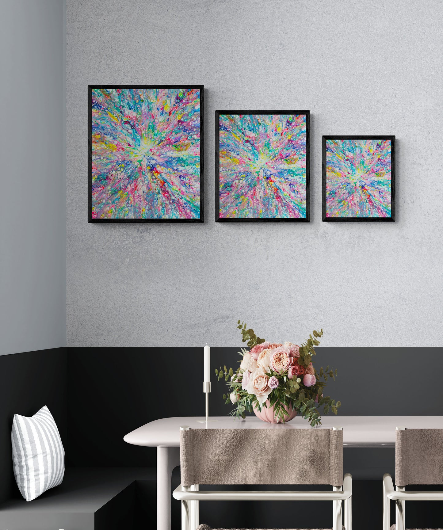 Set of three Rainbow Dragon abstract fluid art prints in black frames, displayed in different sizes above a modern dining table with pink floral centerpiece.