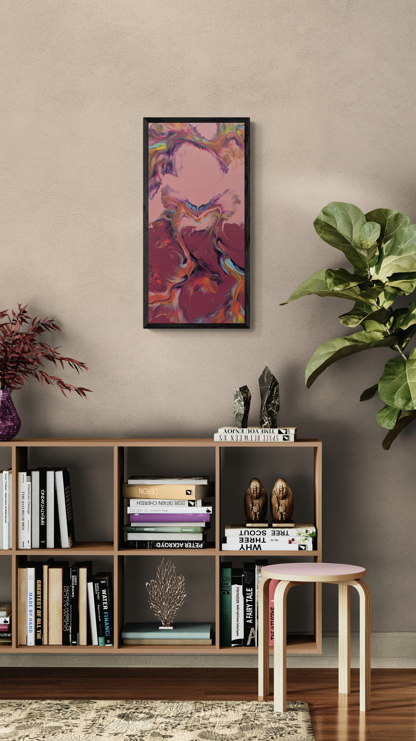 Framed abstract fluid painting with rose, plum, and deep red tones hanging on a beige wall above a modern wood bookshelf filled with books, sculptures, and a potted plant, styled with soft neutral and natural elements.