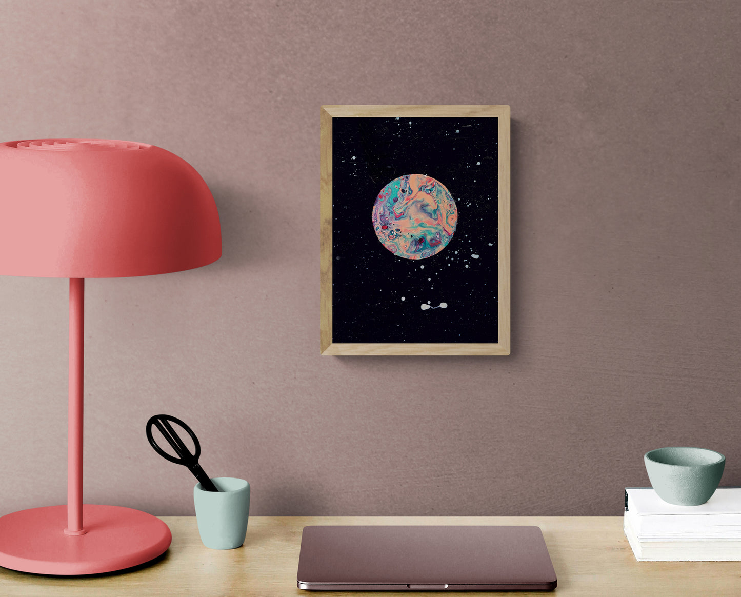 Strawberry Moon art print in a natural wood frame styled above a desk with a coral lamp and minimal decor
