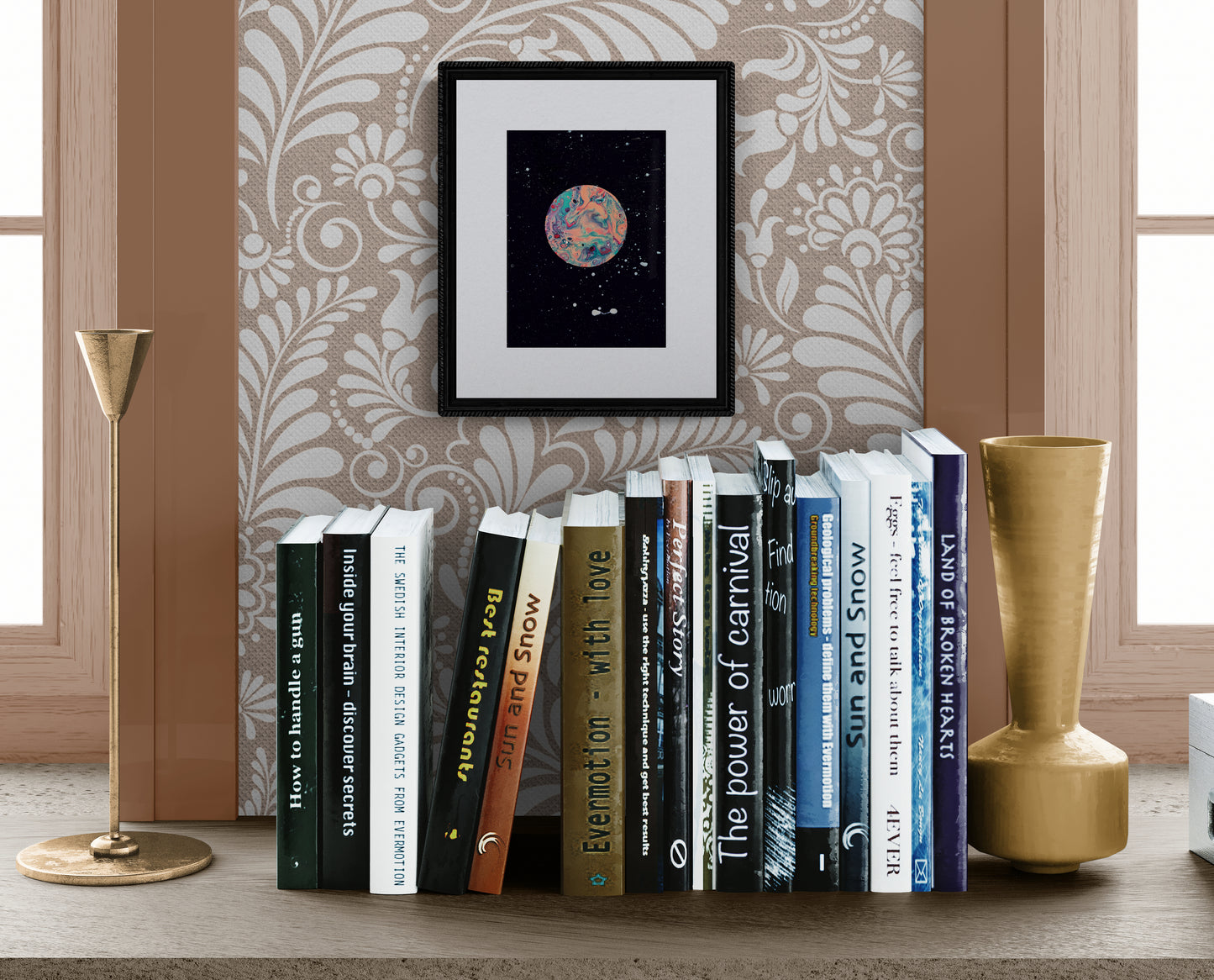 Strawberry Moon framed print on a wallpapered wall above a bookshelf with gold candlesticks and decorative vases