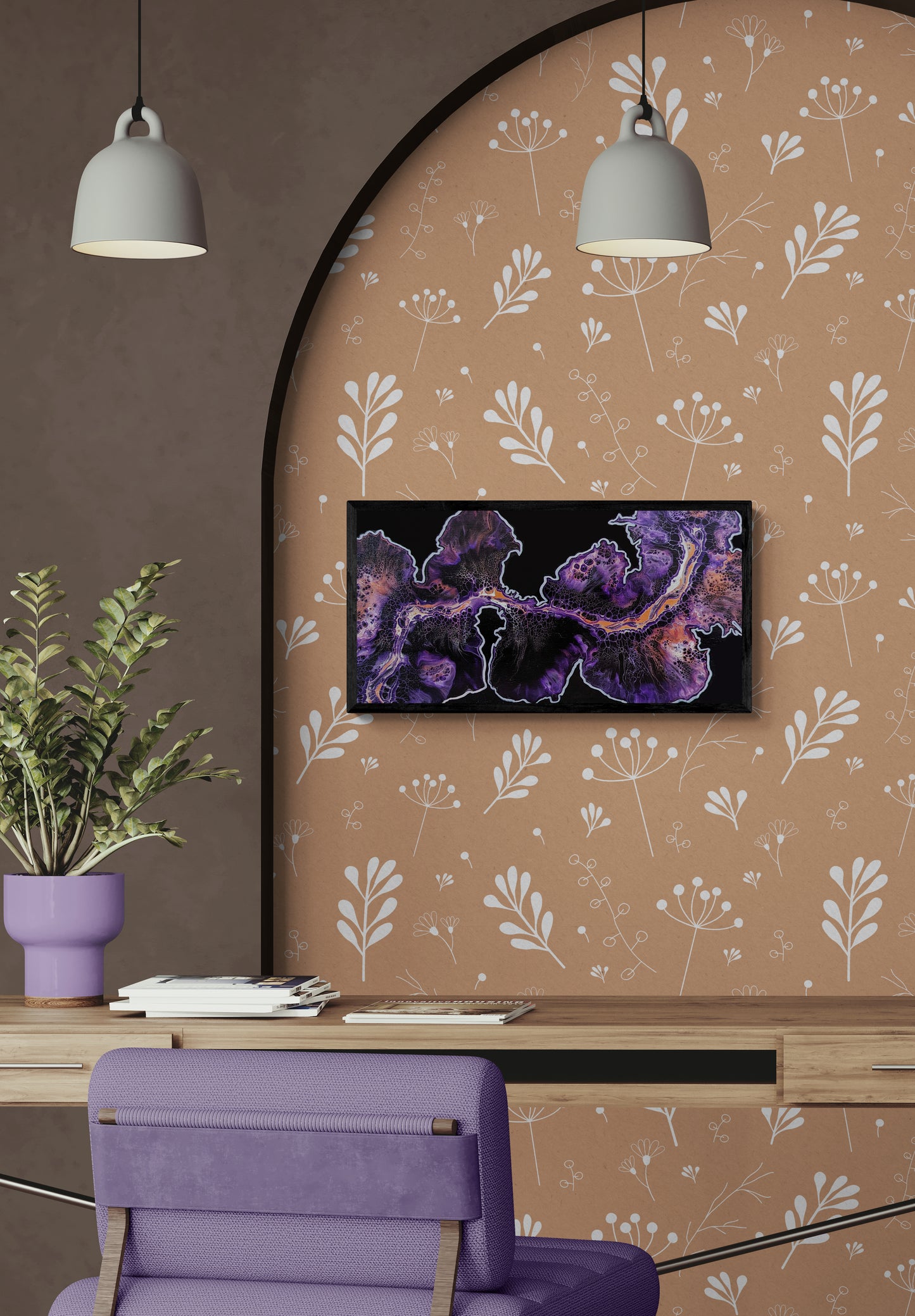 Framed abstract painting with glowing purple, and copper tones displayed above a wood desk in a cozy workspace with a lavender chair and light brown floral wallpaper.