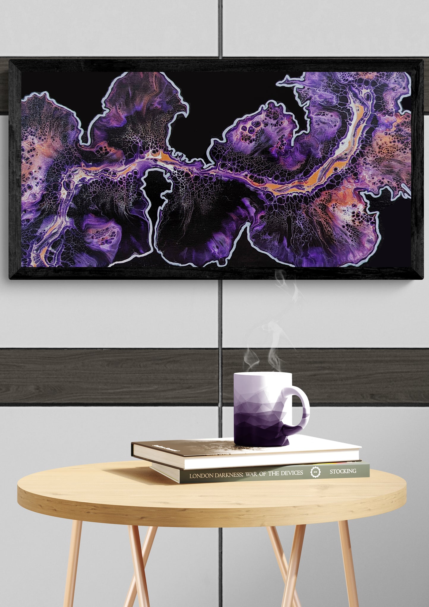 Framed abstract painting with flowing purple, and copper tones on a deep purple background, hanging above a round wood table with stacked books and a purple-toned mug releasing steam, set in a modern, minimalist interior.