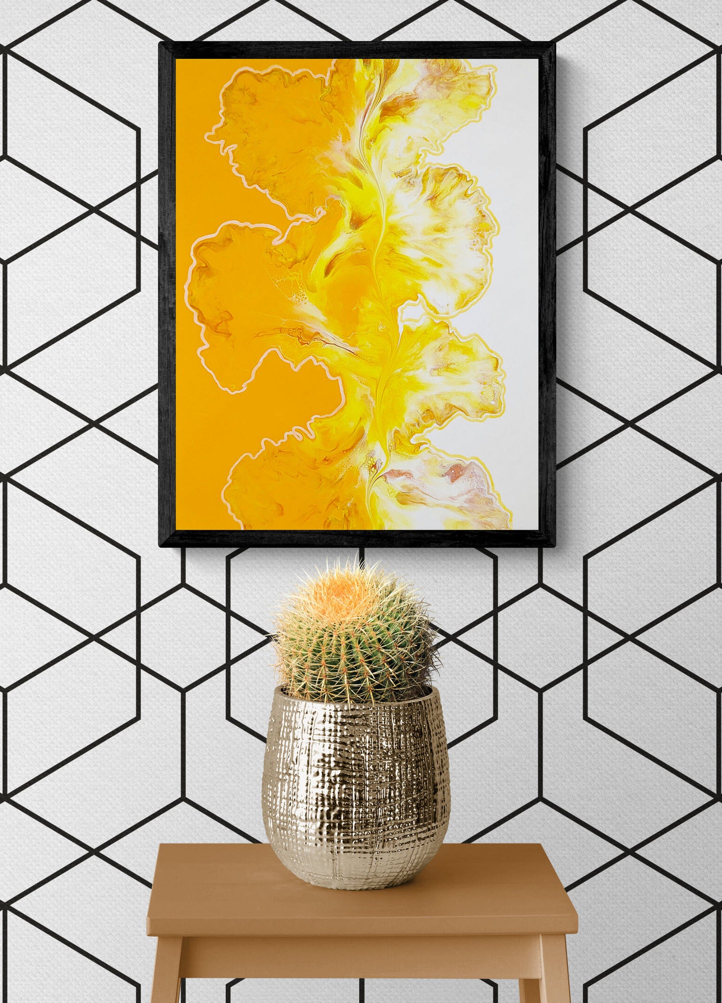 Contemporary wall art print "Walk the Line" in vibrant golden yellow with organic fluid textures, showcased above a cactus plant in a stylish geometric patterned room.