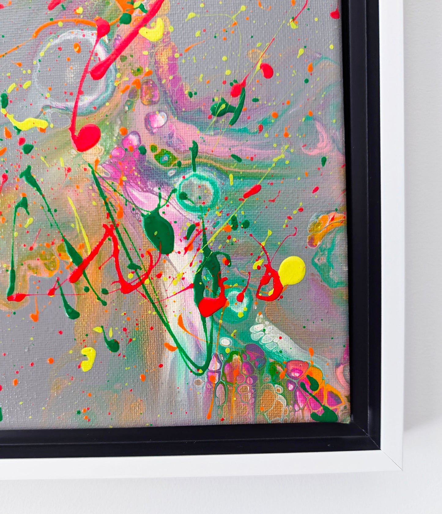 Detailed view of the bottom right section of an abstract painting, highlighting neon drips, bold green and red splashes, and layered translucent texture.