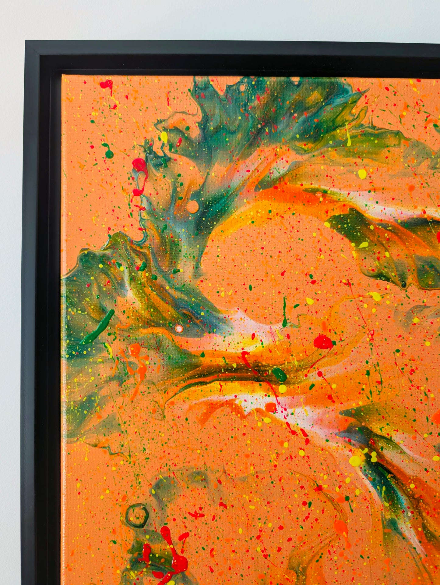 Close-up of the top left corner of 'Are You Really Going Out in That?' highlighting bold green and orange marbled patterns over an orange base, with scattered red, yellow, and orange splatter.