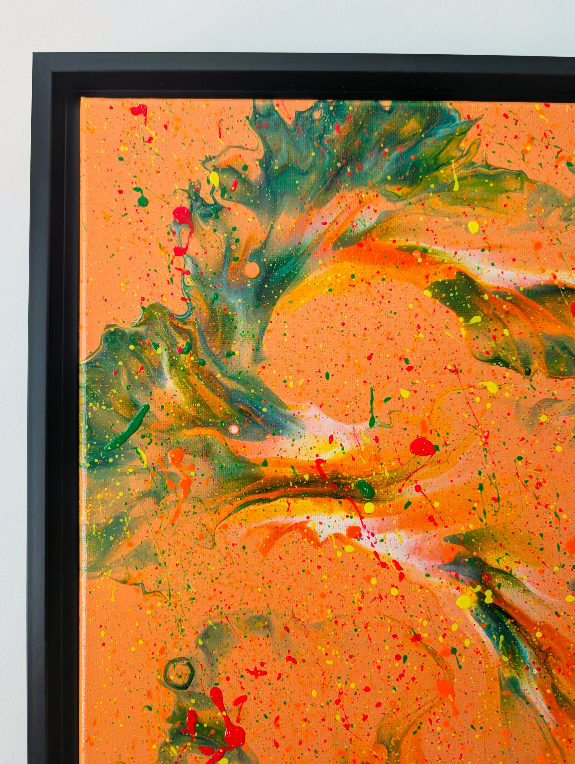Close-up of the top left corner of 'Are You Really Going Out in That?' highlighting bold green and orange marbled patterns over an orange base, with scattered red, yellow, and orange splatter.