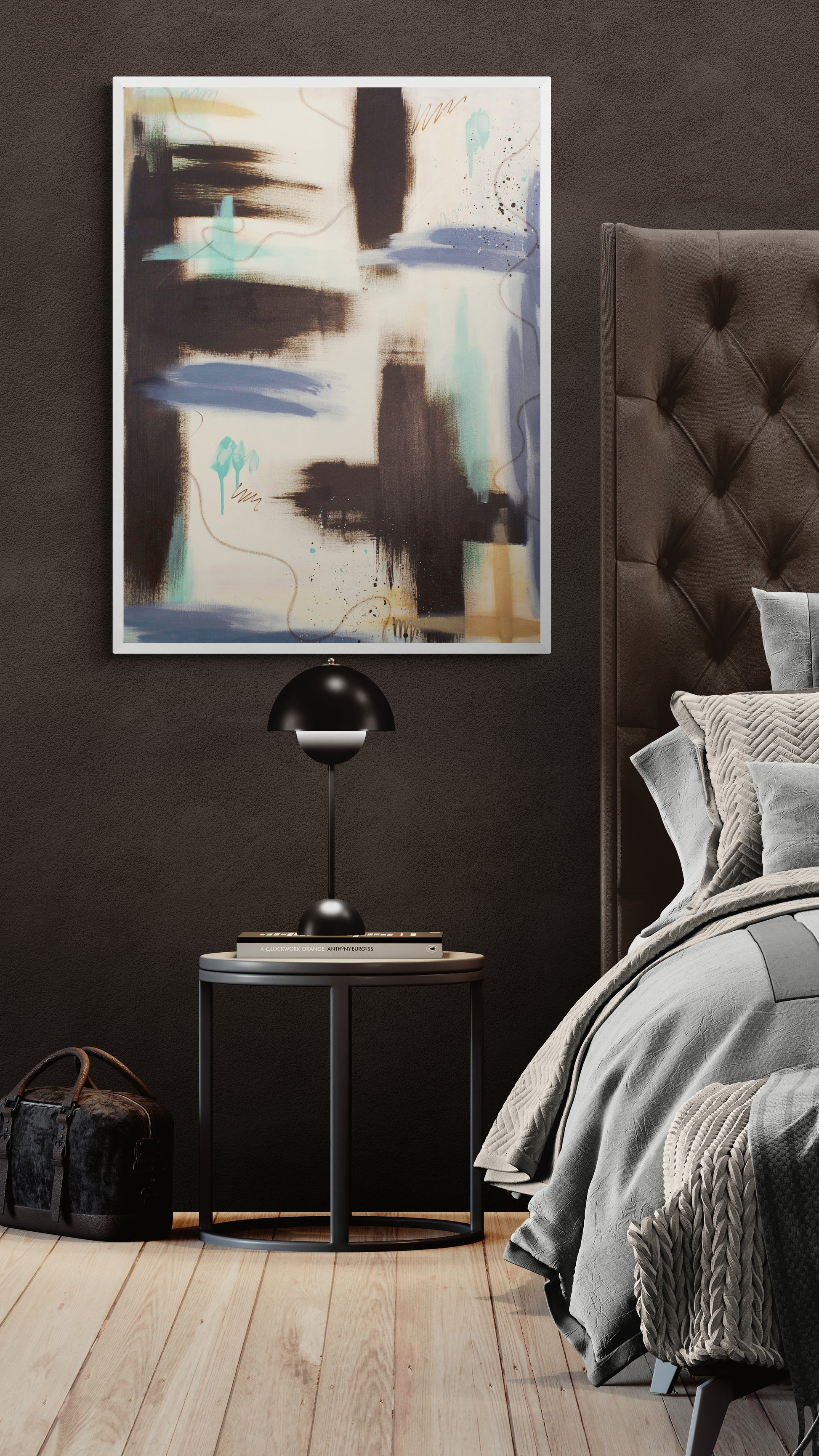 A vertical, unframed abstract painting titled "Between the Layers" hangs on a dark, textured charcoal wall. The piece features heavy strokes of raw umber and teal, with lavender and light blue horizontal bands and thin, wandering oil pastel lines. It sits above a round black nightstand with a modern dome lamp.