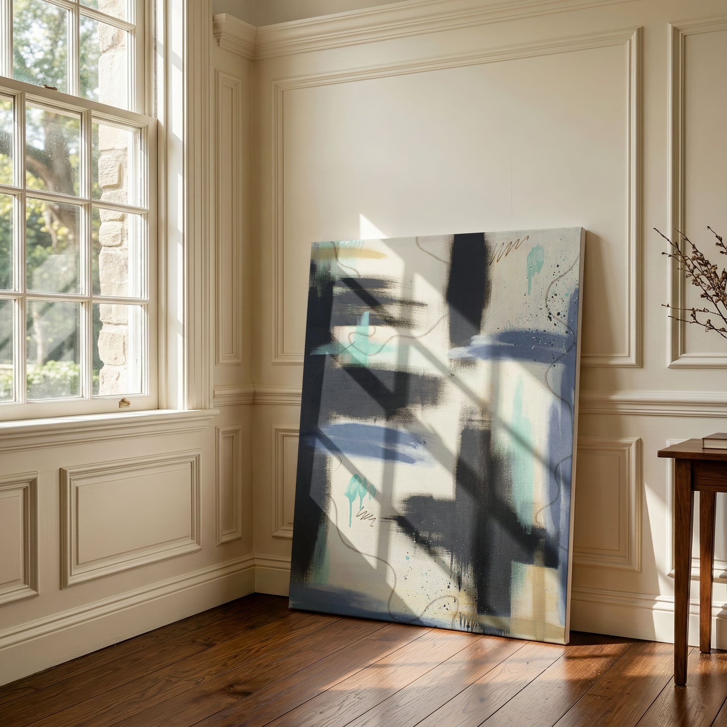 A large canvas print of the painting sitting against a wooden floor, leaning against a cream colored wall. It sits next to a large, paned window with sunlight streaming through.