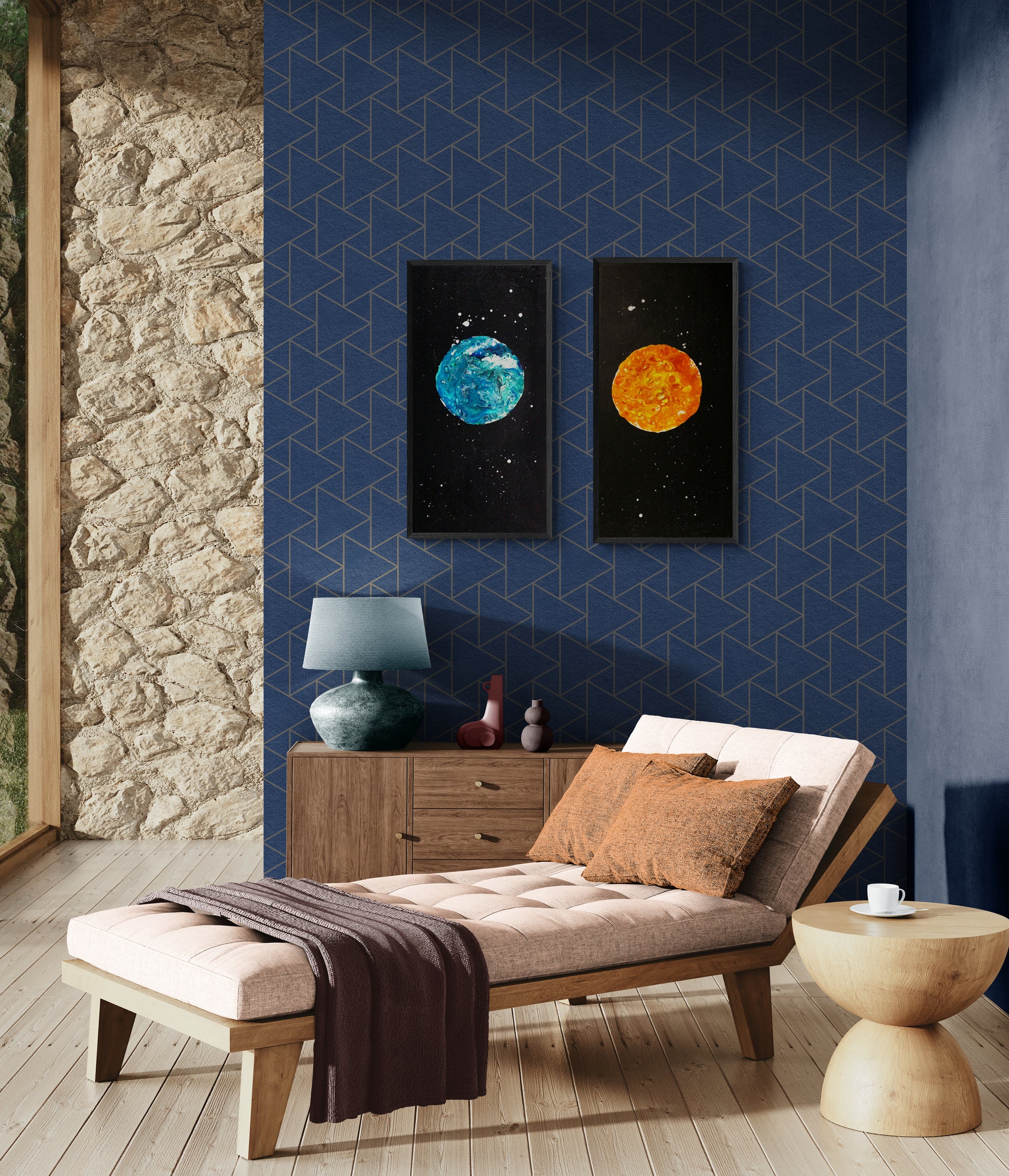 Framed Blue Moon and Harvest Moon fluid acrylic paintings displayed on a deep blue geometric accent wall above a cozy chaise lounge setup.