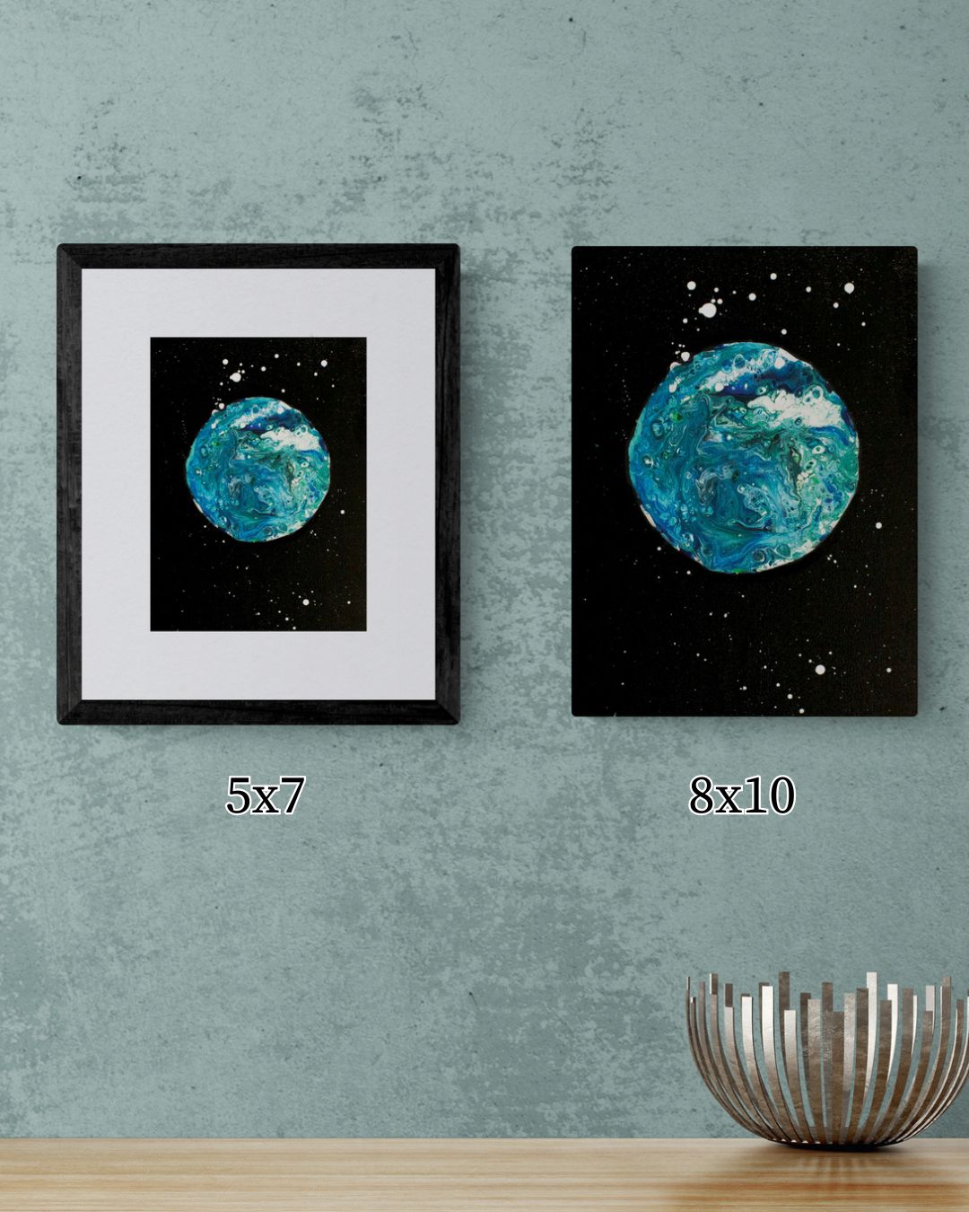 Side-by-side comparison of 5x7 and 8x10 Blue Moon art prints displayed on a green wall with a metallic bowl