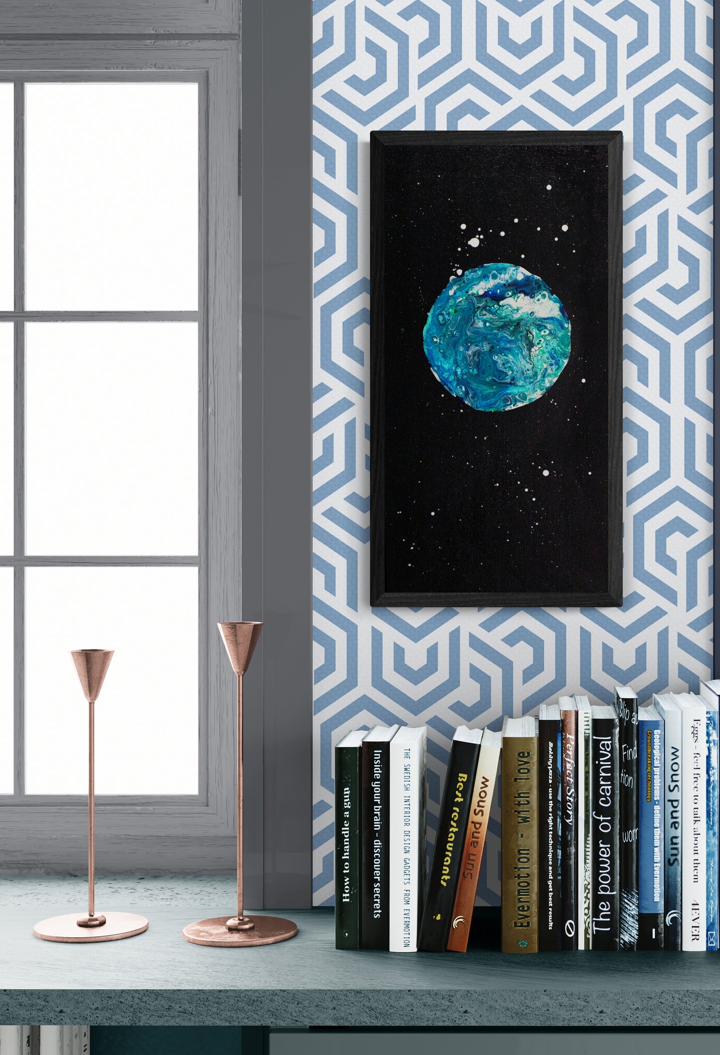 Framed Blue Moon painting displayed in a cozy reading nook with a bookshelf, candlesticks, and geometric wallpaper.