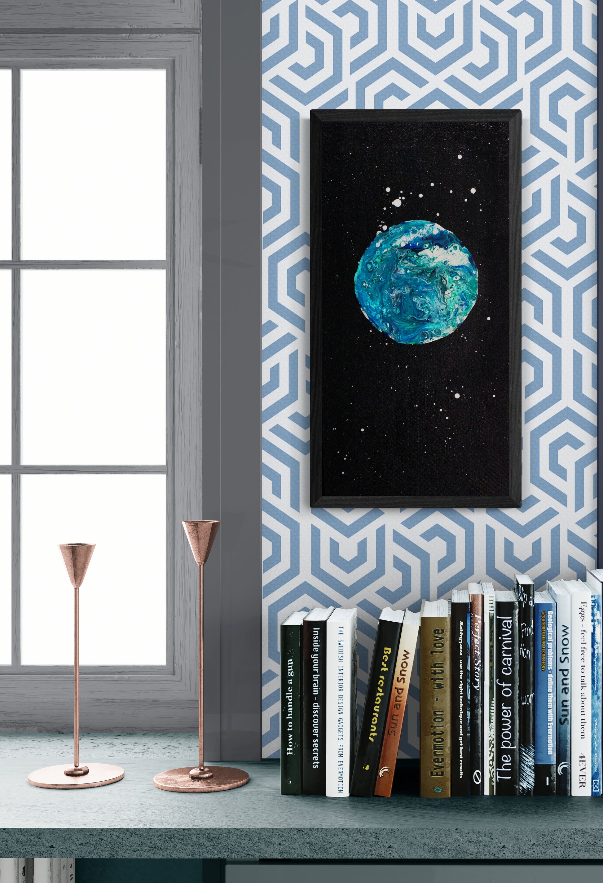 Framed Blue Moon painting displayed in a cozy reading nook with a bookshelf, candlesticks, and geometric wallpaper.