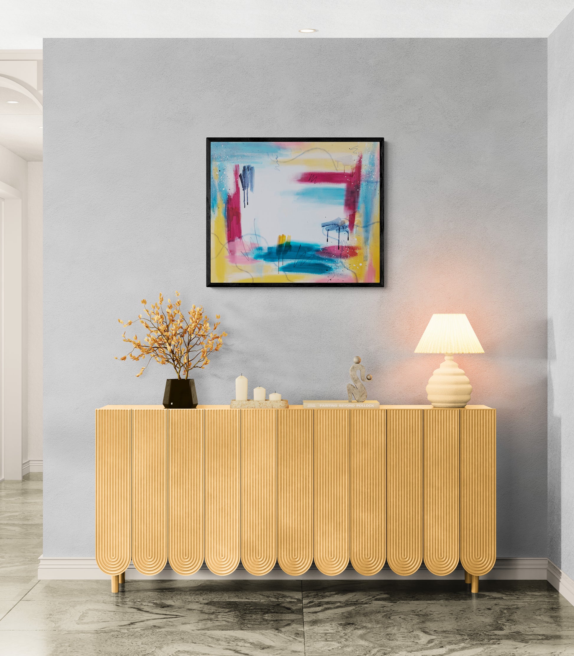 Framed abstract acrylic painting Bright Horizons by Abby May displayed above a modern console table with warm lighting and sculptural decor