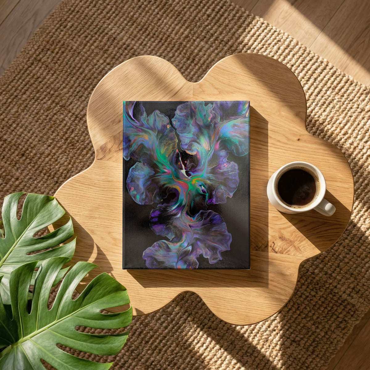 Celestial Dance, an original fluid painting by Abby May, shown in a room on a wooden table beside a cup of coffee.