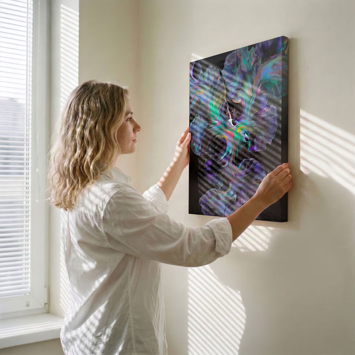 Angle view of Celestial Dance, an original fluid painting by Abby May, showing the canvas edge as it is held against a wall.
