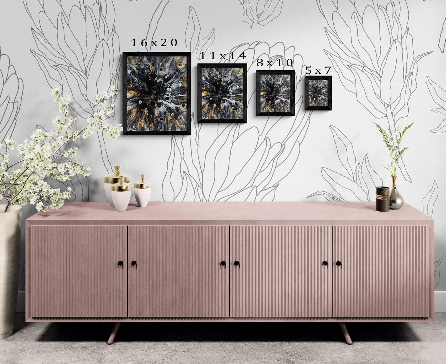 Abstract fluid art prints in black frames shown in four sizes—16x20, 11x14, 8x10, and 5x7—displayed above a blush pink console with floral decor and modern accents