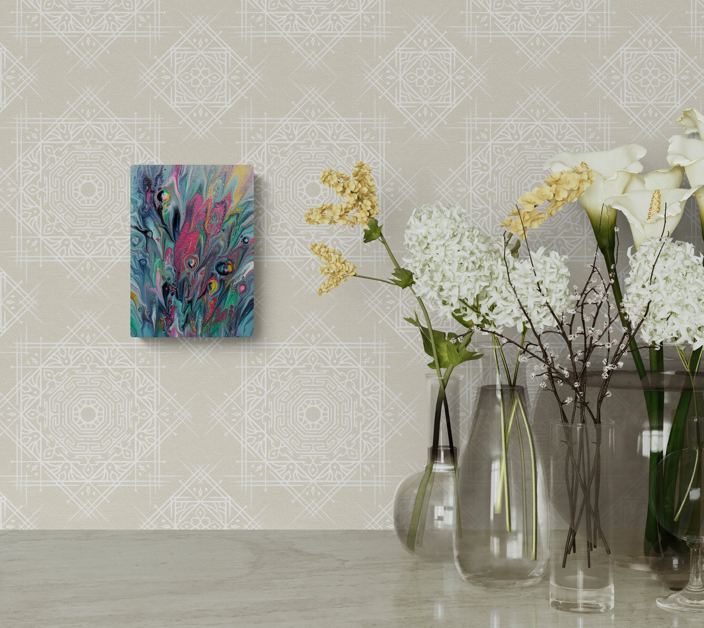 Cheeky fluid art painting displayed on a soft beige patterned wall beside tall glass vases filled with white, yellow, and green florals. The artwork adds a pop of vibrant color to the elegant decor