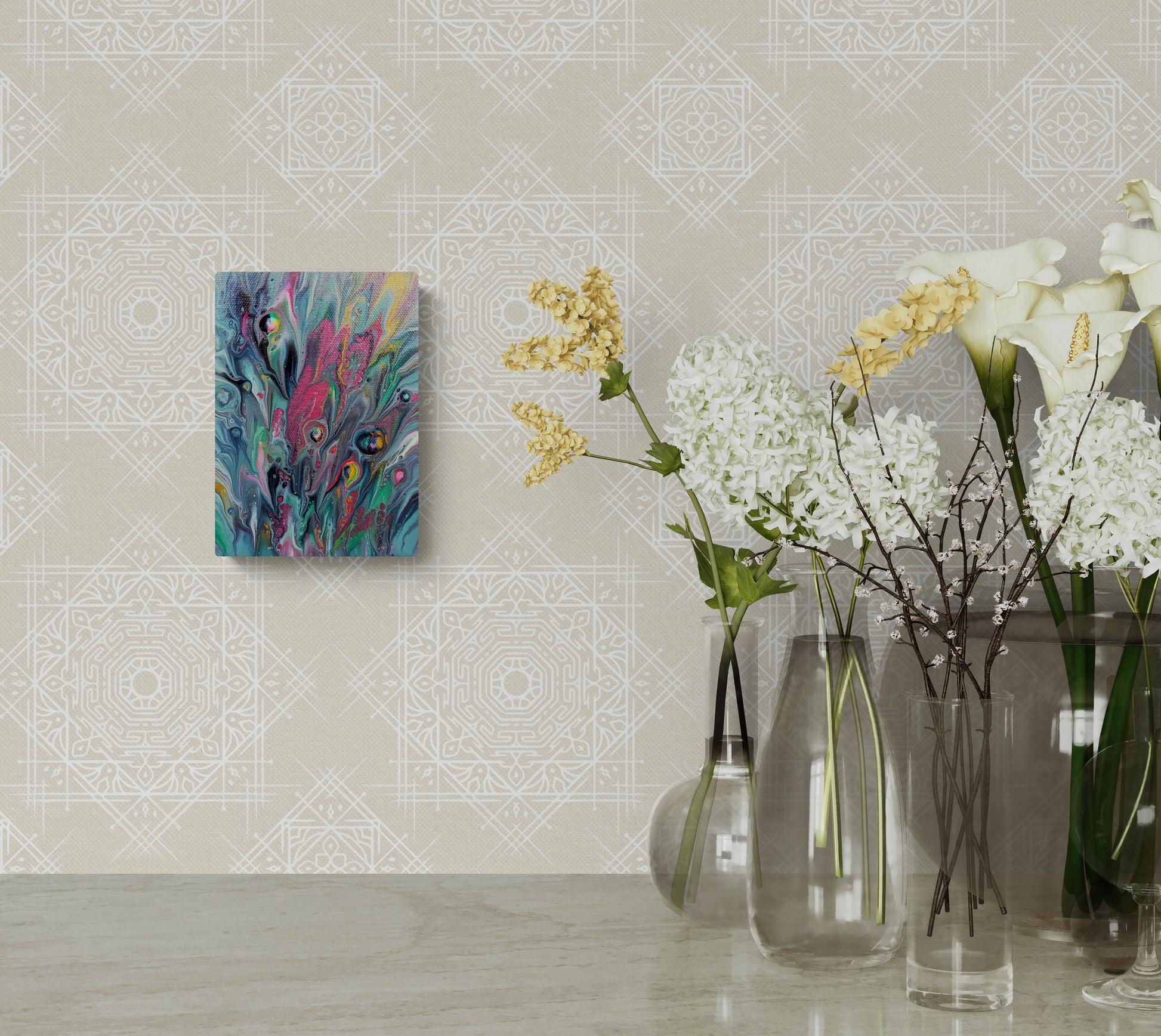 Cheeky fluid art painting displayed on a soft beige patterned wall beside tall glass vases filled with white, yellow, and green florals. The artwork adds a pop of vibrant color to the elegant decor