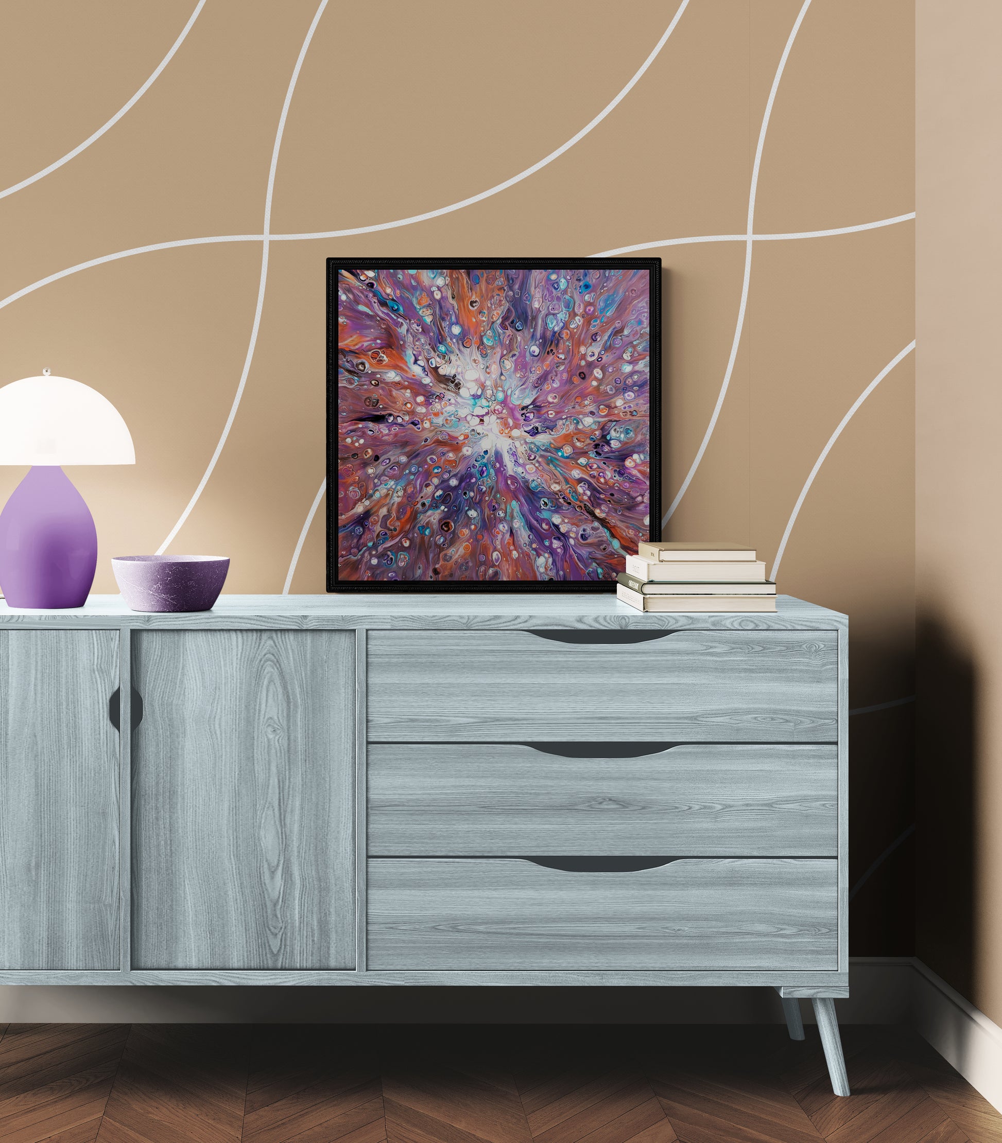 Elusive Kitsune fluid art painting framed in black, styled on a light gray wood sideboard with a warm beige curved pattern wall, soft violet lamp, and neutral home decor.