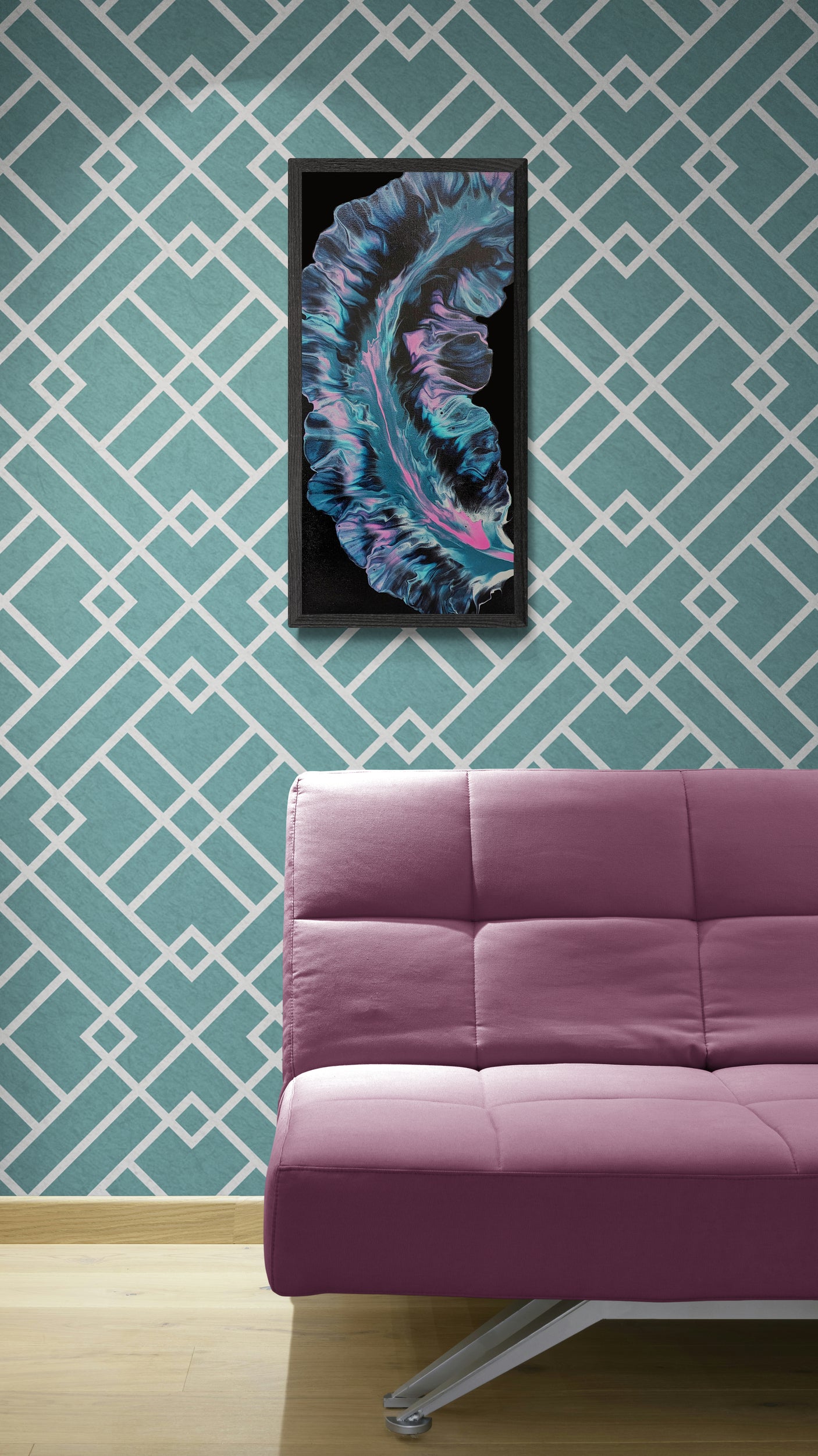 Framed abstract painting with flowing aqua, pink, and deep purple tones on a black background, displayed on a teal geometric wall above a magenta modern couch in a minimalist living room.