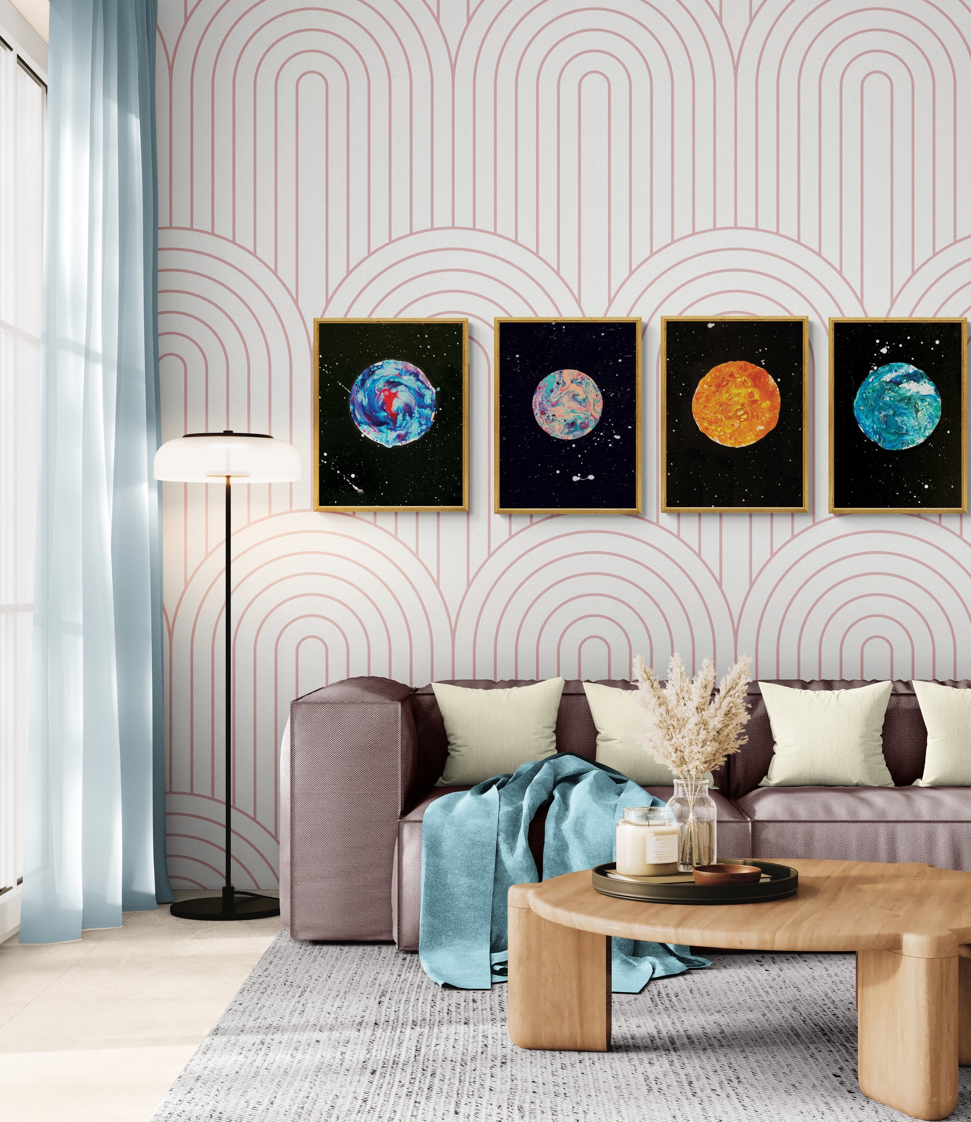 Set of four abstract moon art prints displayed in gold frames above a mauve sofa with pink arch-patterned wallpaper
