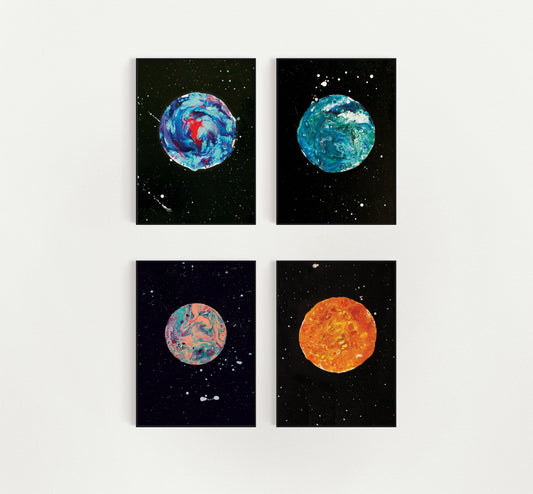 Flat lay of the In Her Orbit print collection featuring four abstract moons on white background in black frames