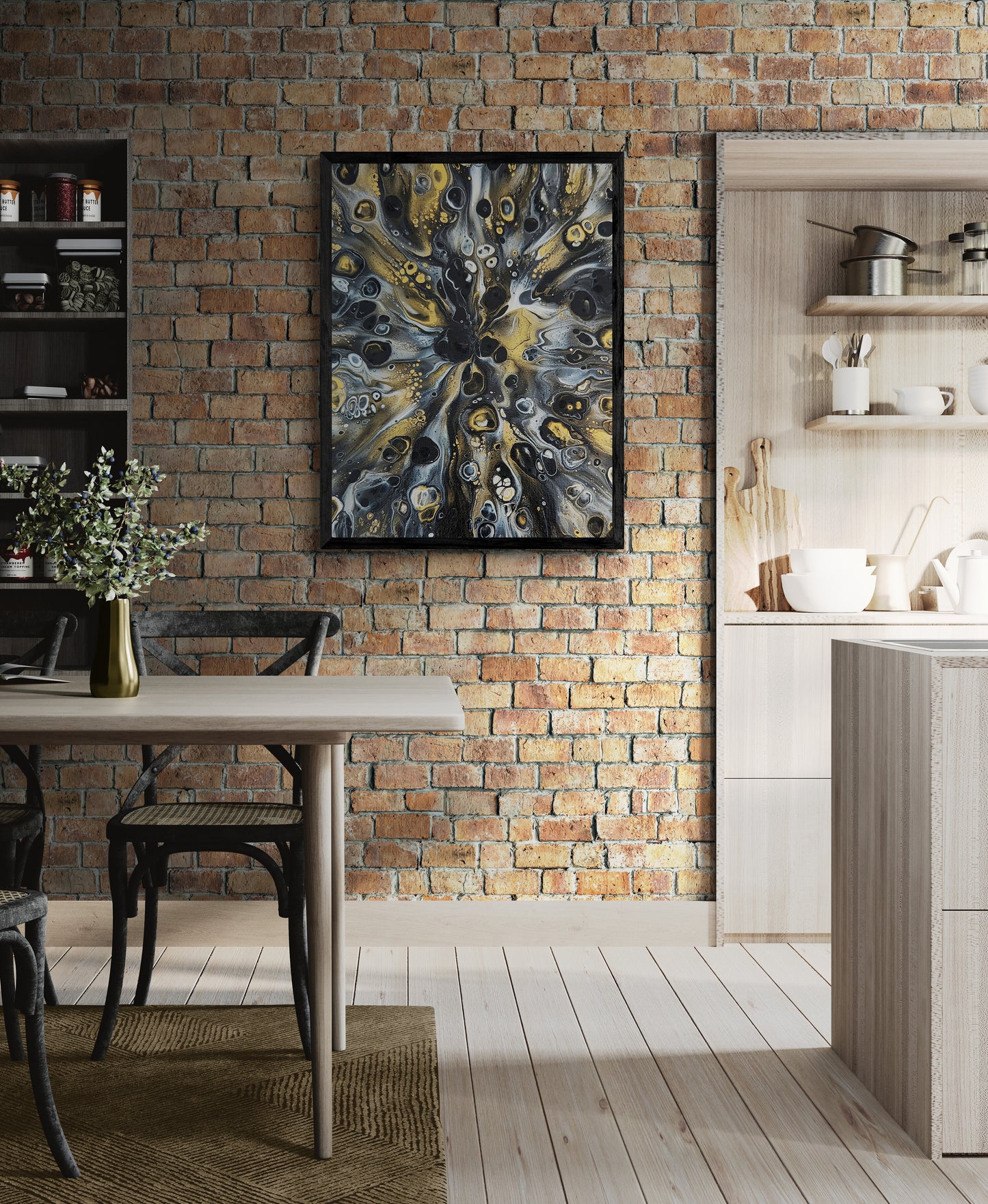 Abstract fluid art print in black and gold displayed on an exposed brick wall in a cozy kitchen with wood furniture, shelves, and modern rustic decor.