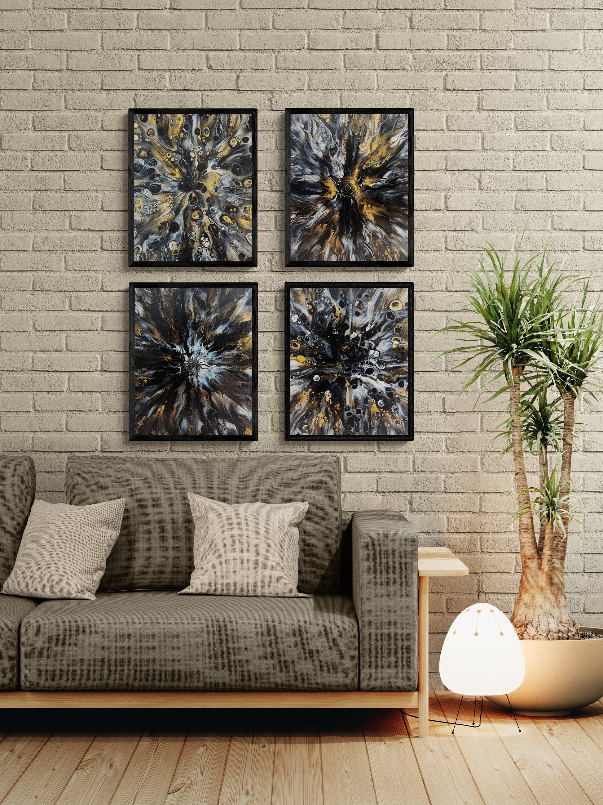 Set of four abstract fluid art prints in black and gold tones, framed in black and arranged in a grid above a modern gray sofa with beige pillows and indoor plants