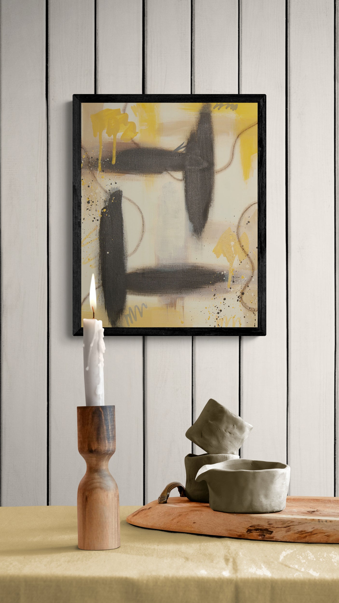 "Golden Kindling" original painting by Abby May styled above a candle and modern decor, highlighting the grounding raw umber elements and radiant, warm energy.