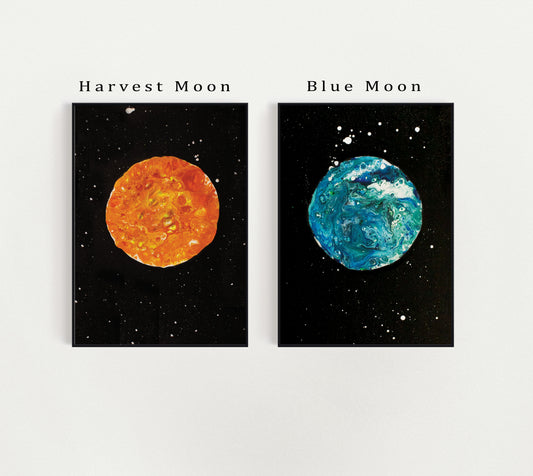 Labeled image of Harvest Moon and Blue Moon fluid art prints with text identifiers above each print; vibrant orange and blue tones against a black cosmic background.