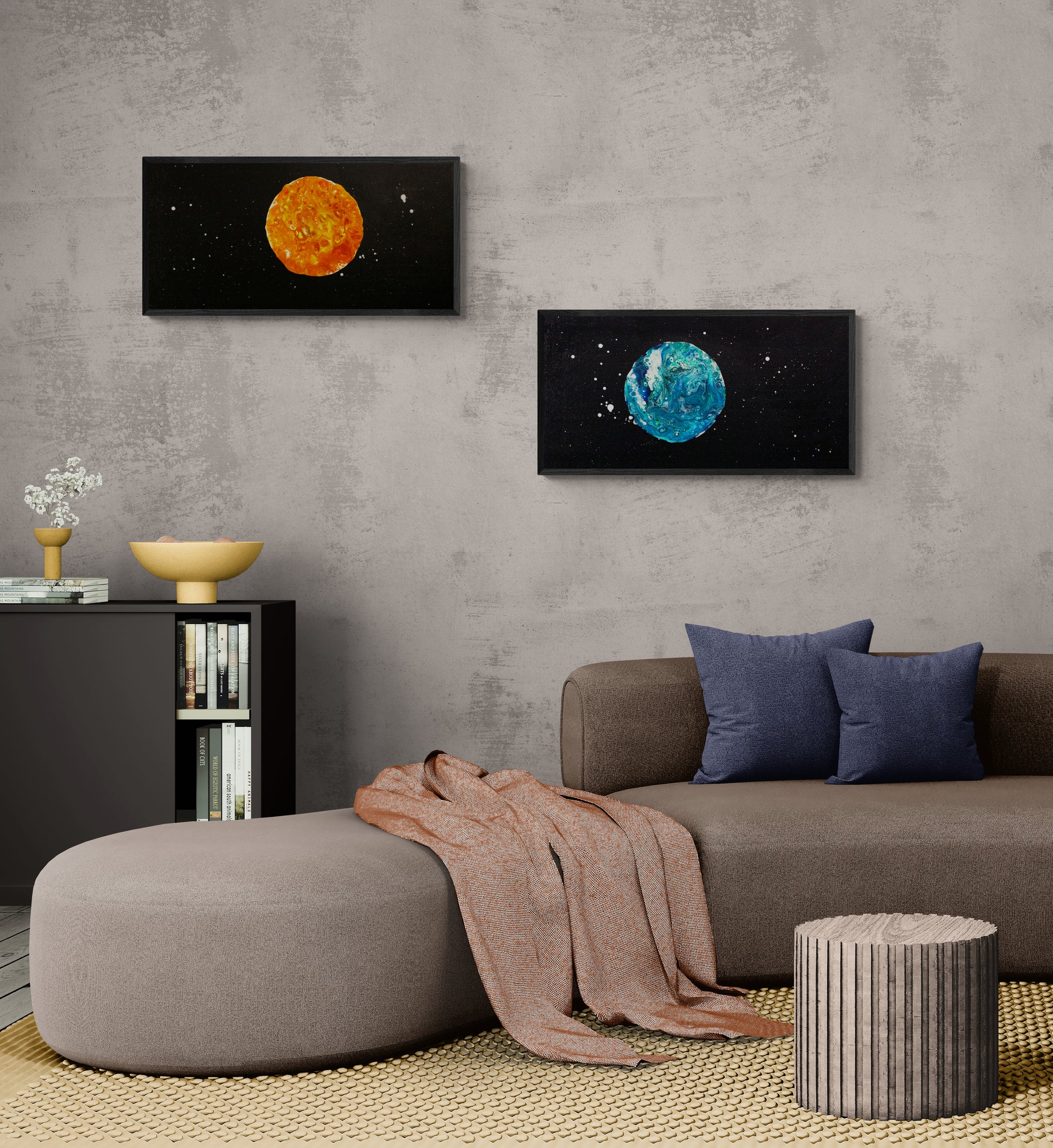 Blue Moon and Harvest Moon acrylic paintings displayed horizontally side-by-side on a gray wall in a contemporary living room with earthy-toned furnishings.