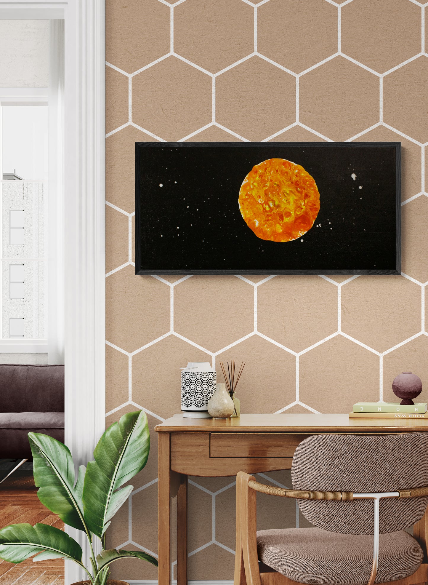 Harvest Moon original painting styled above a light wood desk and hexagon-patterned wallpaper, blending warm autumn hues with modern decor.