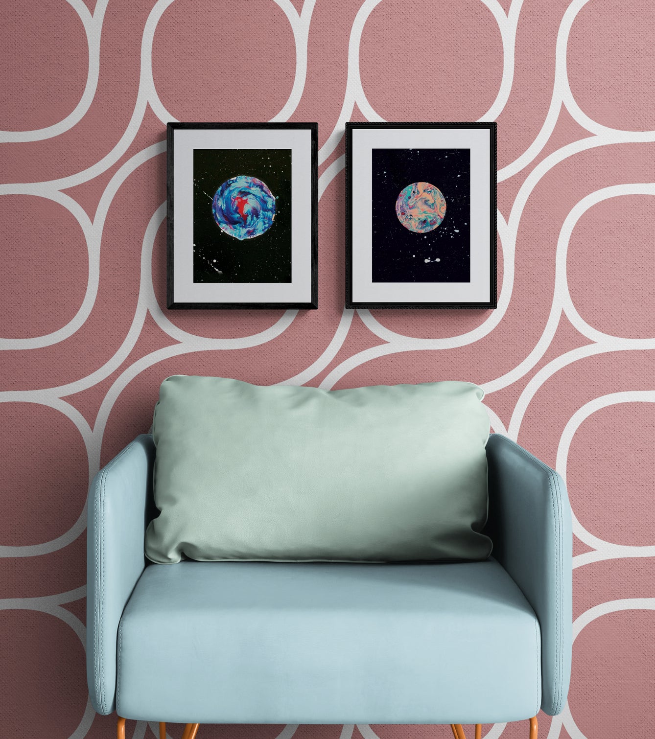 Her Majesty The Moon and Strawberry Moon prints in black frames mounted above a light aqua accent chair; retro pink wallpaper with a white mod circle design.