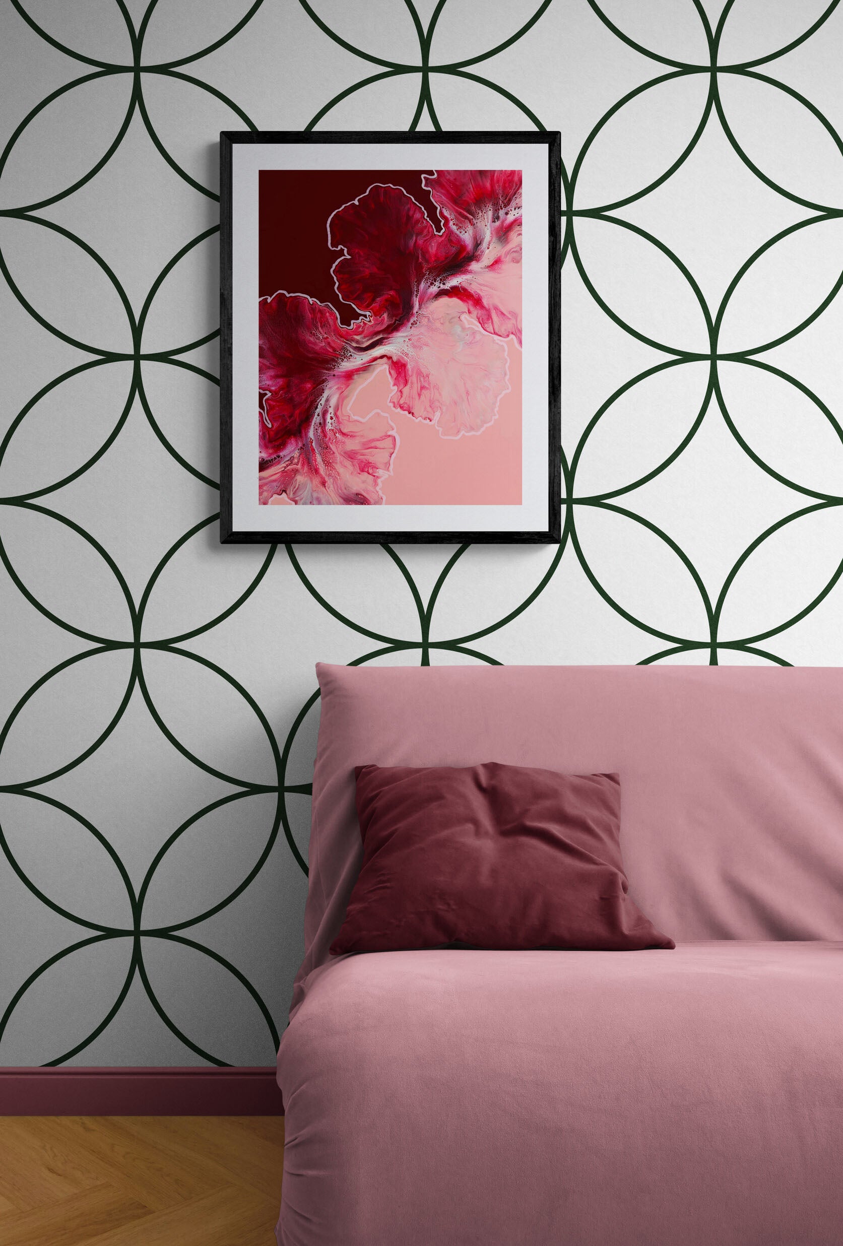 Framed Hold the Line fluid art print in red and pink hues, styled above mauve sofa with geometric patterned wallpaper.