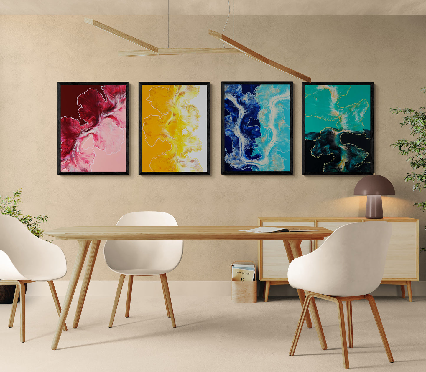 Set of four abstract fluid art prints—red/pink, yellow/white, blue/teal, and turquoise/black—framed in black above a modern dining table with white chairs.